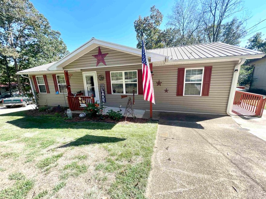 Beautifully remodeled 3 bed 1 bath LAKEFRONT home on the famous "LAKE CHEROKEE" in Cherokee Village AR!  This FRESHLY remodeled home offers everything you need for the perfect lakehouse living. Inside, you’ll find new vinyl plank flooring, solid wood doors, and a luxurious walk-in tiled shower with glass doors. The kitchen shines with quartz countertops and a deep stainless sink, ideal for cooking and entertaining.  Enjoy outdoor living on the 38-foot deck (built in 2022) with peaceful lake views. A new sliding glass door, metal roof, and new septic system (installed June 2025) add lasting value. The basement offers storage or expansion potential, and the chain-link fenced backyard is perfect for pets or children.  With a gentle slope to the water—not steep—you’ll love easy access for fishing, kayaking, or relaxing on your private dock. This move-in ready lakefront home is a rare find in Cherokee Village, AR, perfect as a full-time residence, weekend getaway, or vacation rental investment.