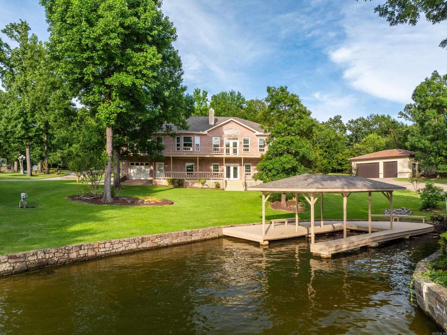 Spacious Lake Home on a Beautiful Level Lake Lot in Area of Upper End Estates, Located on the Popular Lake Hamilton Little Mazarn cove, Great Sunset Views on Lake Hamilton, Granite Counters in Kitchen land Bathrooms, Enclosed Sun Room upstairs, Oversized 3-Car Garage in Front, Plus Lower Level Garage/Shop, Basement has second kitchen and Second Laundry room, Save on Electric Bills (Credit every month) with Approx. 15kw Solar System, 98% LED lighting, Covered stationary Boat Dock, Roof Re-Shingled in 2024, Home and Property in Great Condition. No Nightly Rentals.