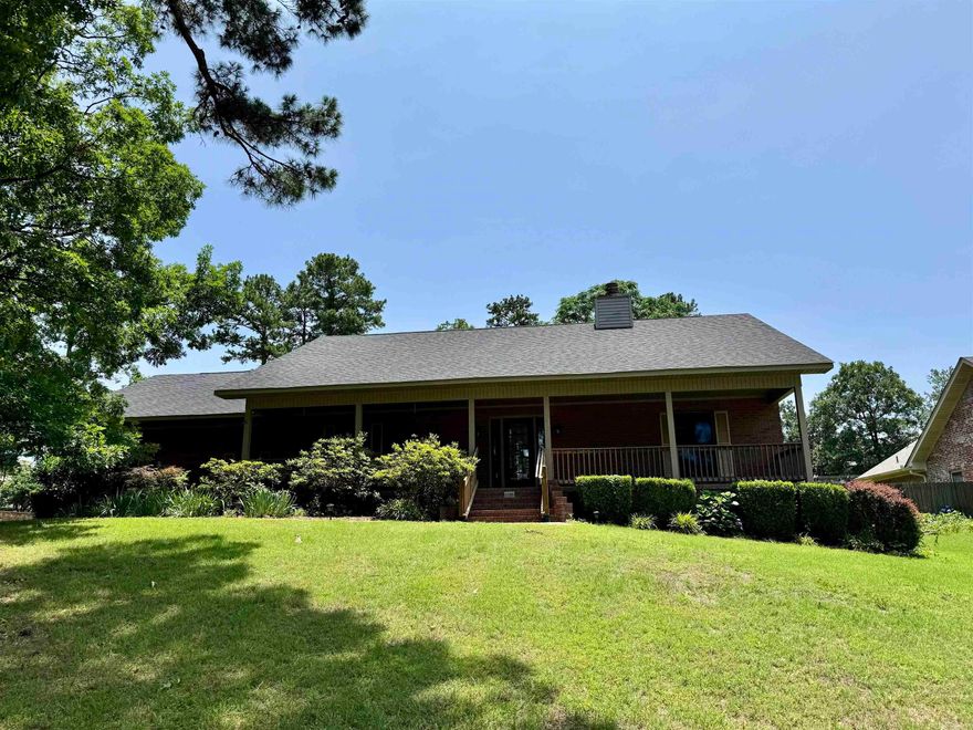 This pristine home overlooking Lake Hamilton has deeded lake access.  Very well maintained and loved and is move in ready.  The living area features a large brick fireplace with vaulted hardwood ceilings.  Formal dining with breakfast nook in the kitchen.  Beautiful hardwood cabinets with lots of cabinet space.  Oversized laundry room with office area.  Large primary bedroom with tray ceiling.  Primary bath with separate walk in shower and tub.  Dual large closets.  The guest rooms are on the opposite side of the home.  Enclosed back porch makes a great space for entertaining.  Shop in back is great for storage or possible mancave.  Two car garage with additional covered parking.  Newer kitchen appliances, roof and HVAC replaced in 2023.  Whole house generator installed in 2024.