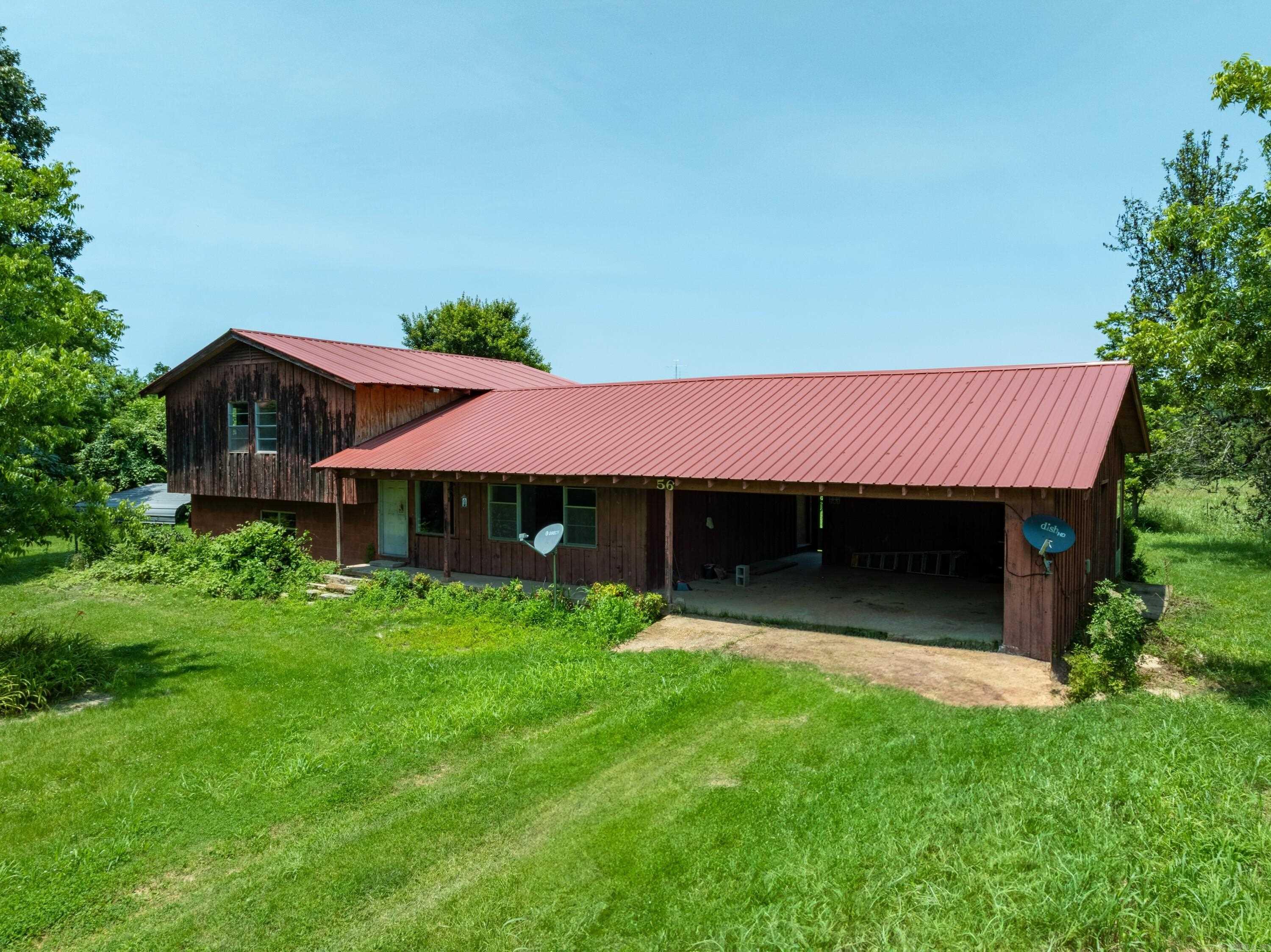 Live the Ozark Dream – 80± Acres with Creek Frontage, Pasture, Shop & Renovation-Ready Home Mac Lane | Just Outside Evening Shade, AR Own a true slice of the Ozarks with this stunning 80± acre property in Sharp County. Located at the dead end of Mac Lane, it offers privacy, beauty, and over 4,400 feet of year-round Piney Creek frontage. The mix of gently rolling pasture and timber is perfect for livestock, hay production, or hunting, with abundant wildlife including deer and turkey. The partially renovated 2,100± sq ft home is ready for your finishing touches and features a spacious living room with wall-length fireplace, open kitchen/dining area, built-in office, upstairs primary suite, and a lower-level den, bedroom, full bath, laundry area, and a walk-in storm/root cellar. A small shop sits under the carport. Farm-ready improvements include a large maintenance shop with a bridge crane and a hay barn with ample storage. This property is irrigated from Piney Creek (per seller), and its productive hay fields yield strong annual bale counts. With mature shade trees,room to ride ATVs,plant gardens,and endless views, this is the ideal setup for your farm,retreat, or forever home.