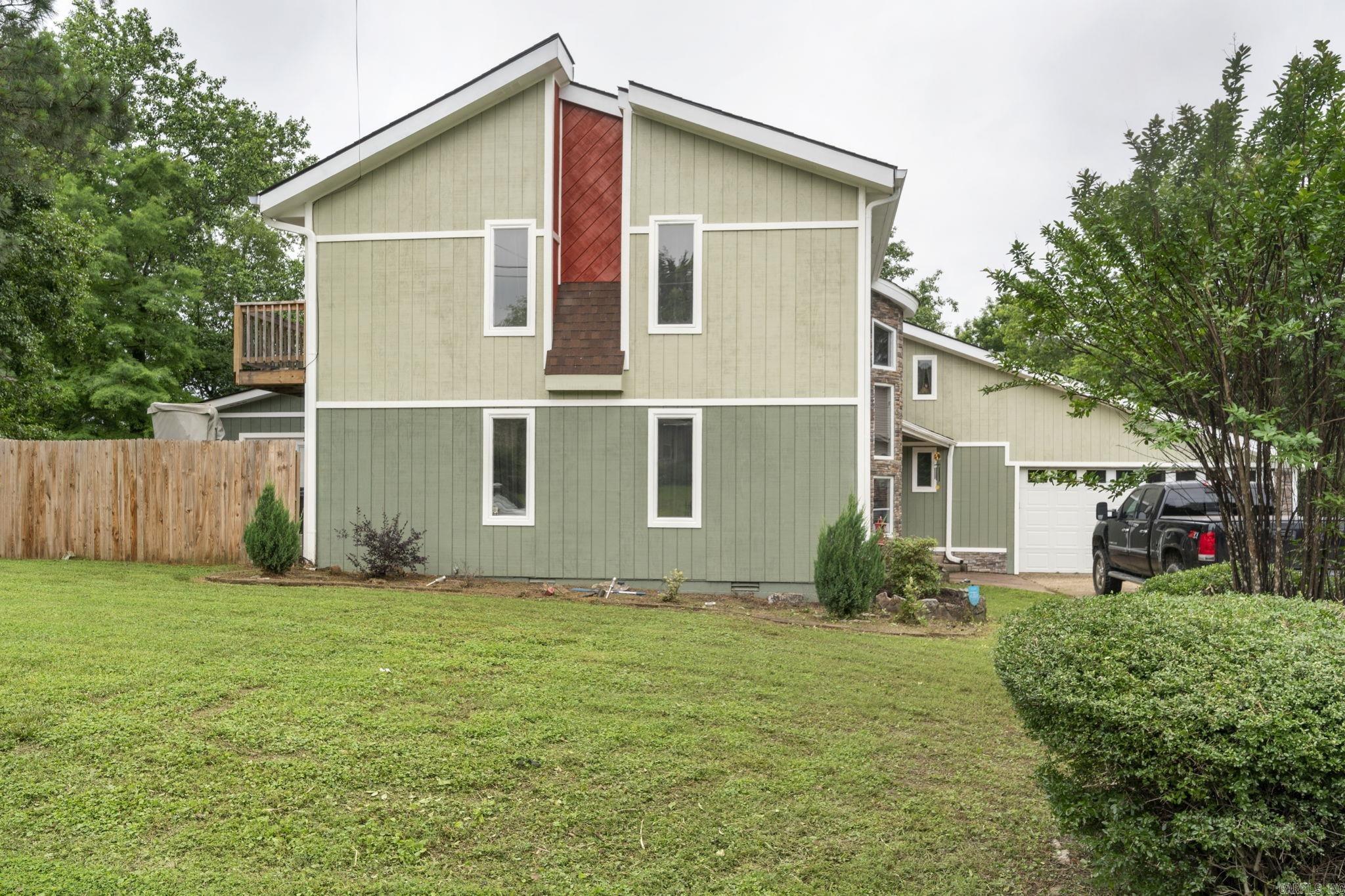 Fabulous opportunity in Hot Springs! 6 MINUTES FROM LAKE HAMILTON! Three bedrooms - 2 up and the primary suite is down. Step through the unique foyer into the beautiful open living/dining space. Off of the living room is a large sunroom. The kitchen is BIG and open! Great storage in the kitchen with a pantry and a short hallway walk to the large laundry room. Upstairs are two nice sized bedrooms and another living space. There is also a finished storage space that could be a 4th bedroom. Many updates throughout! All new wood siding and paint on the exterior. Fantastic composite deck out back for entertaining! Fenced backyard. 2 car garage. CLOSE to so many things! Oaklawn, schools, the lake, shopping and dining! Don't miss this one! No seller property disclosure.