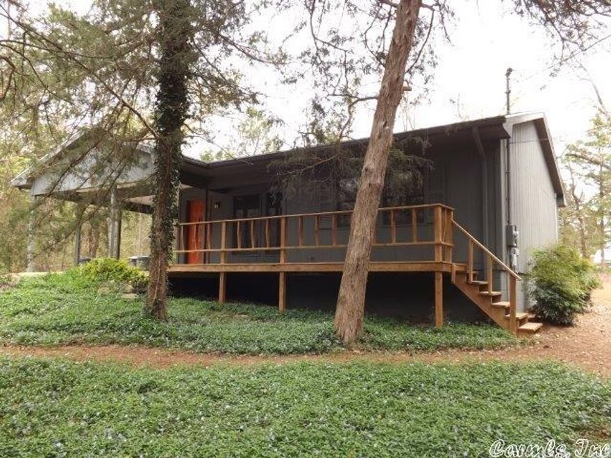 Comfortable Ozark Foothills home nestled in the woods.  2 nice sized bedrooms, 1 full bath, 6" walls, insulated doors and windows, central heat pump for heat and air, wonderful natural landscaped yard, established vegetable garden, 12x12 frame shop/storage building, 2014 metal roof, beautiful hardwood floors installed in 2012, covered front porch, very low property taxes, and close access to South Fork River fishing and swimming.