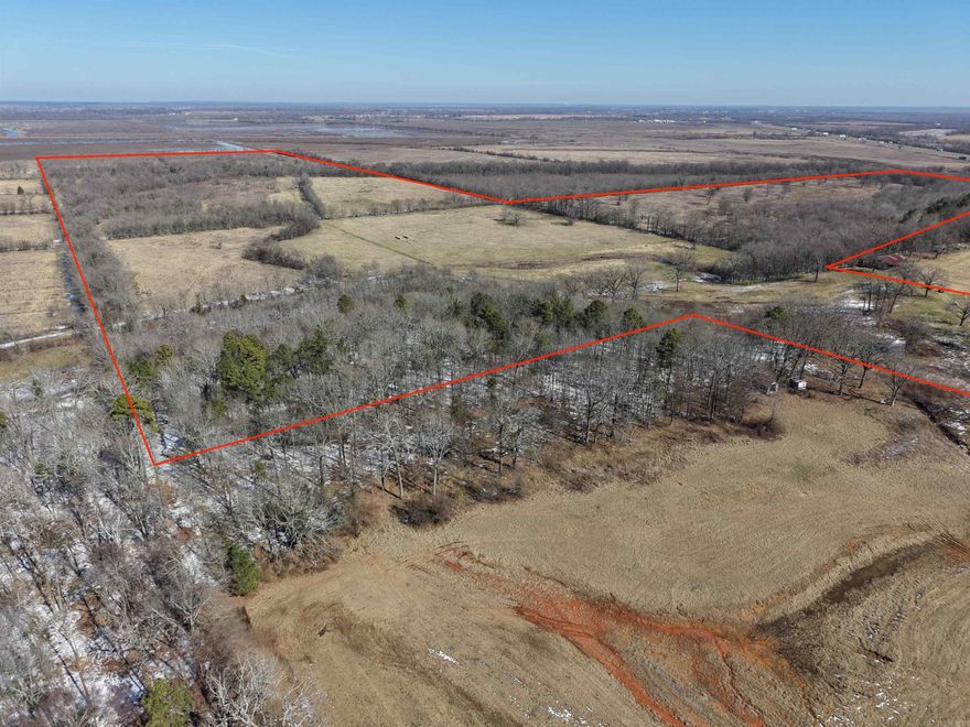 This unique offering includes two lots in Arrowhead Estates totaling 2.7+/- acres, plus 164.4+/- adjoining acres of hunting and farmland directly behind them. The homesites sit within the city limits of Texarkana, while the remaining acreage lies just outside the city limits, offering subdivision convenience with rural privacy.  The 164.4+/- acres feature productive Class III soils suitable for farming and agriculture. McKinney Bayou runs through the north end, with multiple creeks crossing the property to enhance scenery and wildlife habitat. Established bedding areas for whitetail deer and surrounding crop fields create excellent hunting and recreational opportunities.  The elevated homesites overlook the acreage, ideal for building with scenic views. Located minutes from Interstate 49 and Interstate 30, this property offers rare flexibility, accessibility, and investment potential.