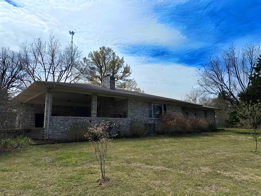 About a mile outside of city limits, you'll find a spacious home in the prettiest setting at 40 Sutton Lane! They didn't skimp on space in this one! The semi open concept kitchen and dining room leave you lots of options for layout as does the large living room with brick fireplace! This home offers 3 bedrooms, 2 of which are MASSIVE (think the size of 2 large bedrooms in one) and they are attached by a bathroom. The other bedroom has an attached bath and you'll find a 3rd bathroom for your guests in the hallway! The yard is stunning and offers room for entertaining out back gardening, and so much more! You'll even have your own chicken coop! In addition to the standalone garage that has had walls added, there are 2 other outbuildings for storage and hobbies!