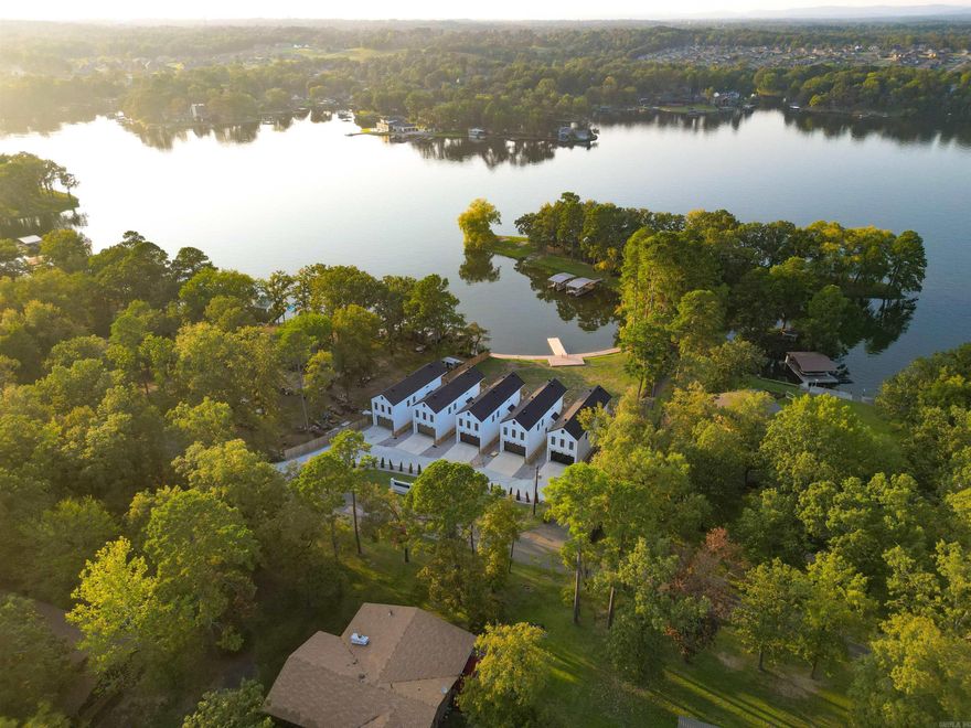**Stunning Lakefront Retreat at Boll Estates II** Welcome to your dream getaway on the picturesque shores of Lake Hamilton! This exquisite property offers an unparalleled blend of serenity and luxury, perfect for both relaxation and entertainment. Enjoy panoramic views of Lake Hamilton from nearly every room in the house, creating a tranquil atmosphere that invites you to unwind. The open-concept design features a generous living room with large windows, allowing natural light to flood the space while showcasing the stunning lake scenery. The fully-equipped kitchen boasts stainless steel appliances, quartz countertops, and ample storage, making it a chef's delight for preparing meals and entertaining guests. This home includes multiple well-appointed bedrooms, each designed for comfort, with plush furnishings and beautiful views, ensuring restful nights. Step outside to your private deck, ideal for summer barbecues, morning coffee, or simply soaking up the sun. A well-maintained lawn leads directly to the lake, perfect for swimming, fishing, or boating. Ample parking space, Ideal for both year-round living and seasonal rentals. NO STR RESTRICTIONS.