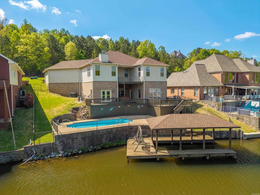 Lake living at its best! Beautiful lakeside home with room for guests, fiberglass pool, boat dock, hot tub, established well-maintained neighborhood! Full house generator. Custom window treatments throughout. Super nice custom built entertainment center in living area. Three bedrooms up and one down. Media room and hobby room both downstairs. Fourth bedroom would make a great office overlooking the lake.  Conveniently located near medical facilities and shopping. Large garage approximately 1079 sq. ft.