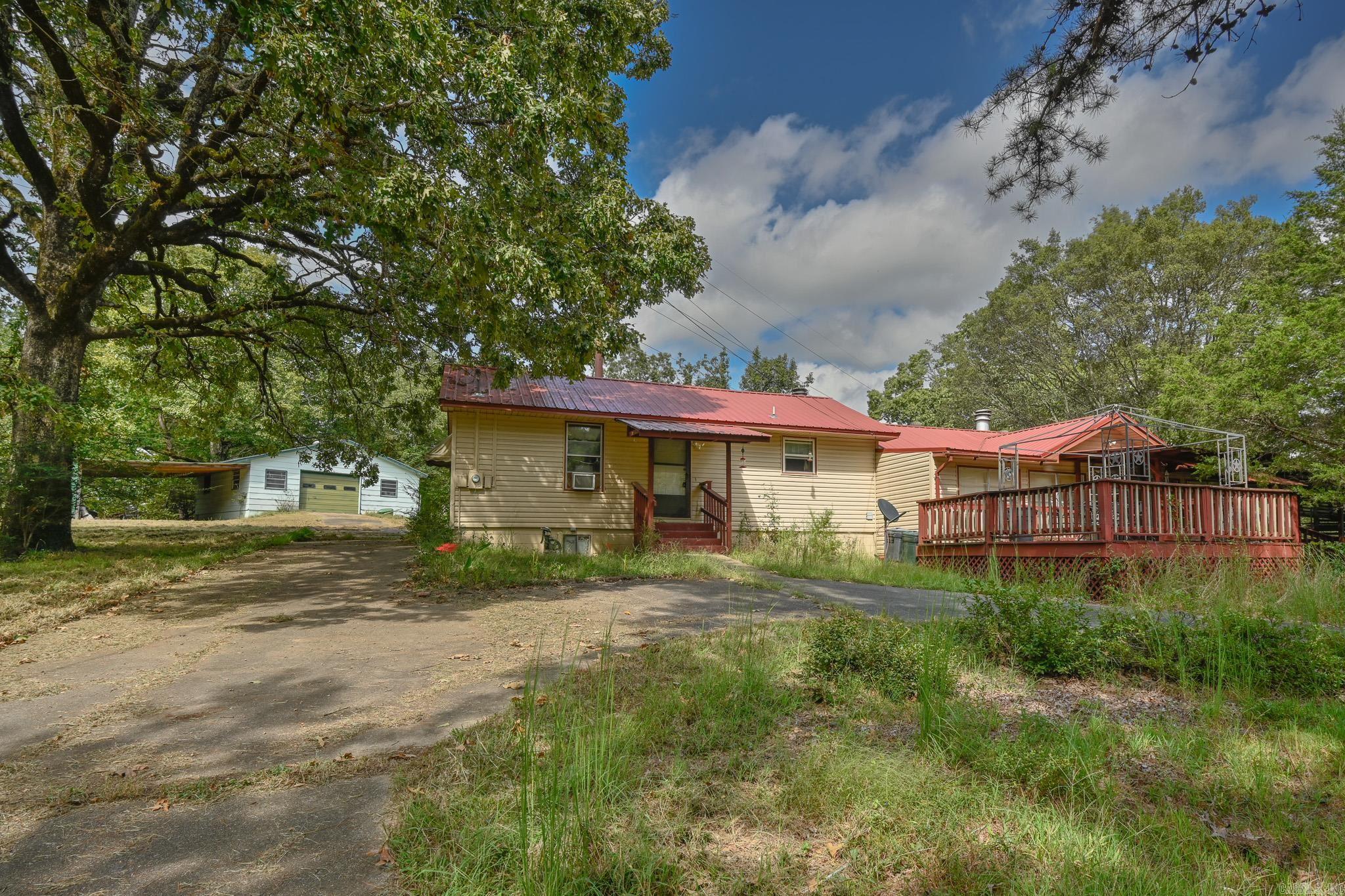 Country living just out of Mena on paved count road. You'll love this spacious country home with sunken living area. Charming kitchen and dining combo with fireplace. Large laundry/utility room. Large basement. Shop for hobbies or storage. Beautiful yard. Porch/Patio area. Detached carport.