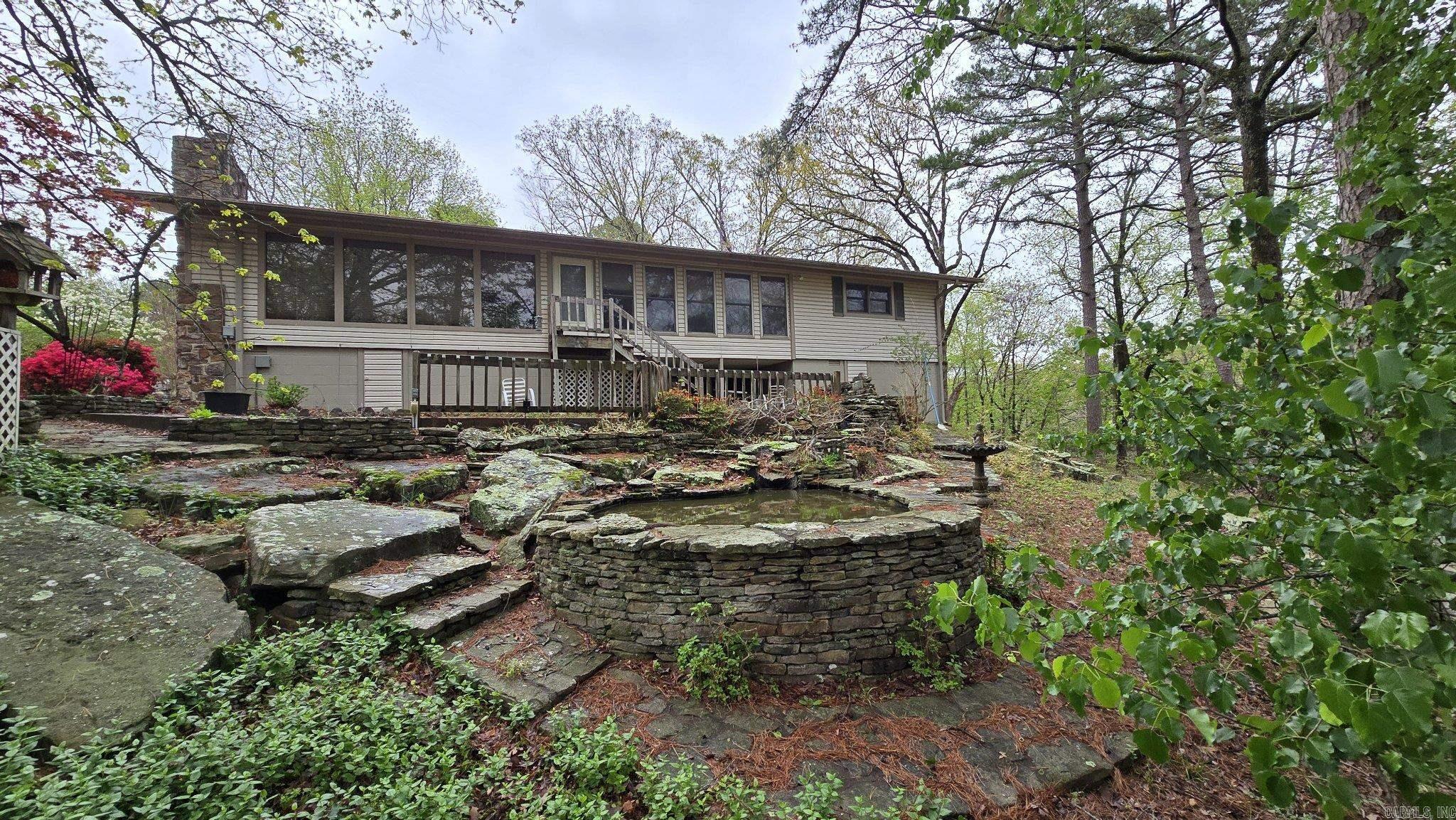 Nestled in the beauty of the Ozarks, this immaculate 3-bedroom, 2.5-bath home offers a spacious open-concept layout with floor-to-ceiling windows filling the space with natural light. Features include a bonus living room, sunroom, gas fireplace, endless storage, and two ponds. Enjoy a small seasonal view of Greers Ferry Lake from the peaceful outdoor setting. Fairfield Bay offers championship golf courses, three pools, mini golf, hiking and biking trails, 90+ miles of ATV trails, and the top-rated Fairfield Bay Marina on Greers Ferry Lake. Plus, enjoy local favorites like the bowling alley and The Little Red Restaurant. Landscaping photos coming soon. As a Fairfield Bay native and your dedicated realtor, I’d love to personally show you this home and our amazing community. Schedule your private tour today!