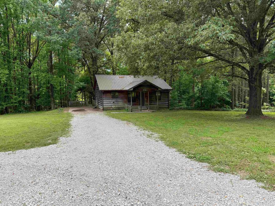 7.5+/- acres including a half acre pond.  A very nice shop building with wood burning stove and a storage building.
