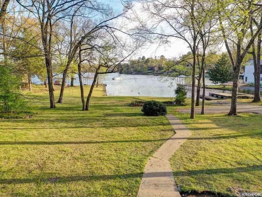 Large vacant Lake Hamilton lake lot with boat dock, swim pier and launch ramp. Build your dream home with enough land for a second garage/shop or guest house. Nestled in the Sunset Bay area just off the main channel and located near shopping, restaurants and Oaklawn Race Track and Casino.  Owner is licensed Arkansas Realtor.