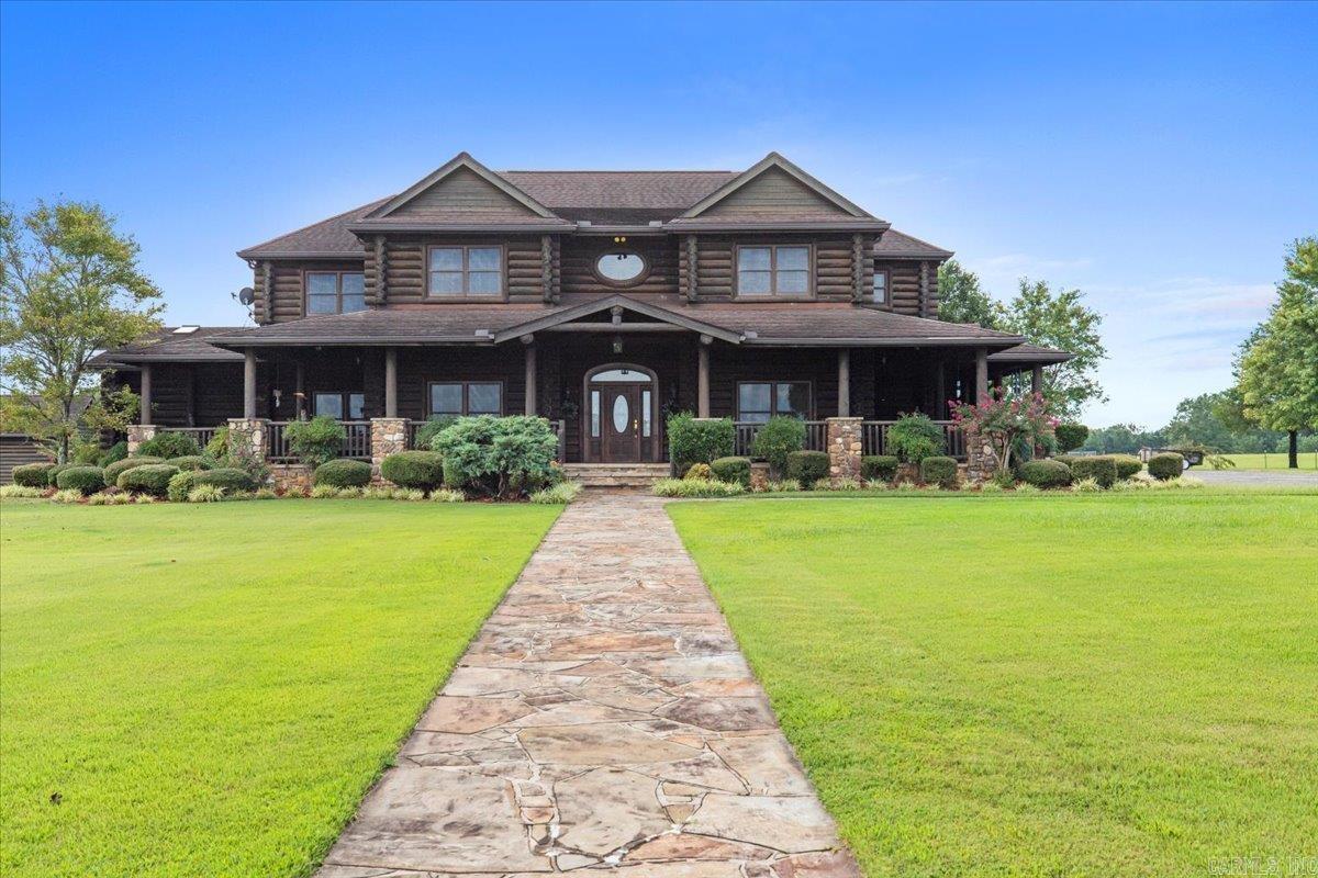 Stunningly crafted log home sitting on +-150 acres overlooking a 16 acre stocked private lake. Located 10 minutes South of Sheridan & less than an hour from Little Rock, the primary residence boasts 9460 square feet (8350 living area plus 1100 heated and cooled 3 car garage). An additional 2300 sq ft home, detached shop with walk-in cooler and cleaning station, equipment shed, horse barn, and boat dock with small boat house are included. Would be perfect for a large family, hunting lodge, or working ranch!