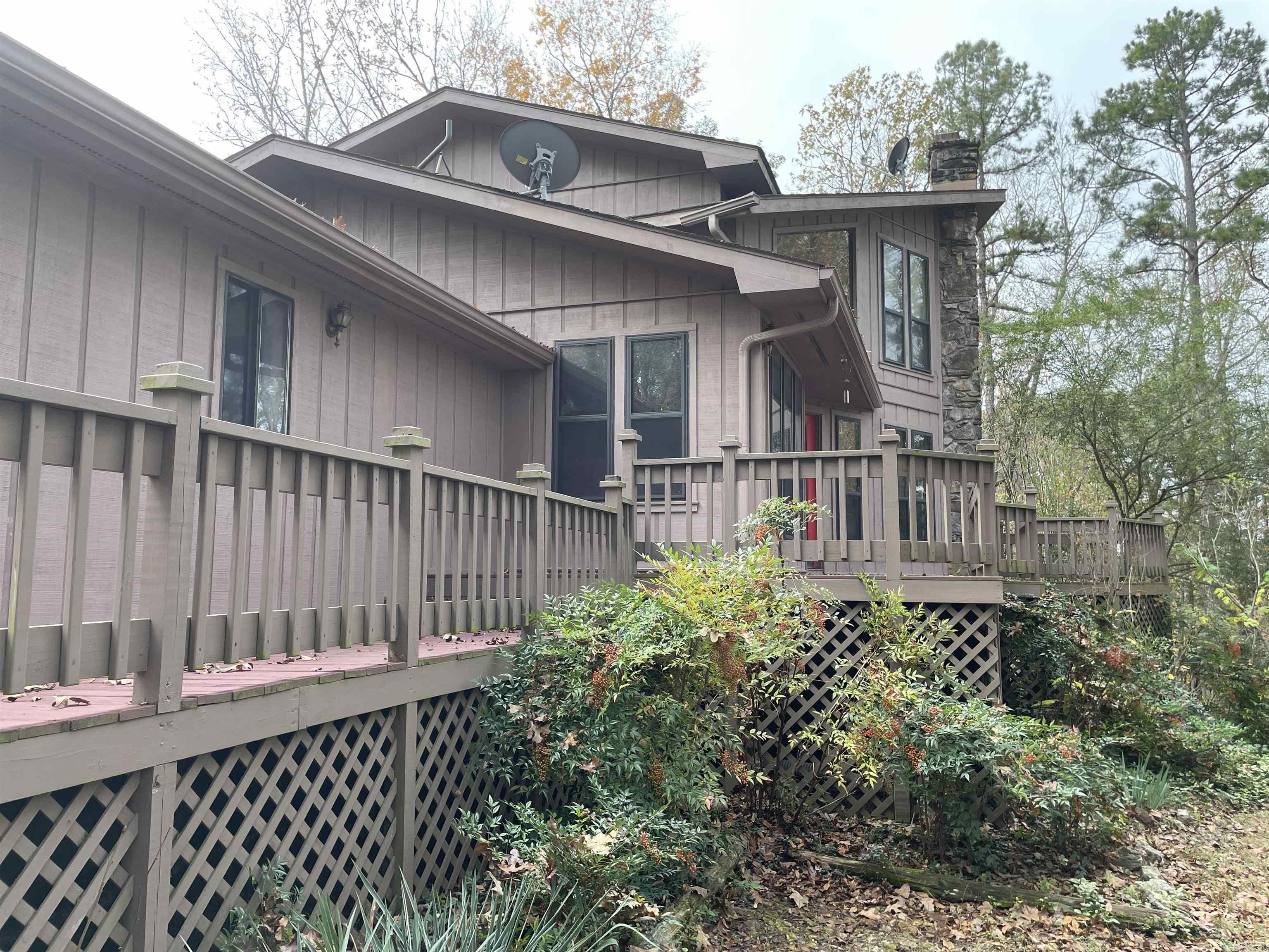 Discover your perfect lake retreat or year-round chalet atop the Lake Forest Estates Subdivision of Tumbling Shoals! This 2,024 SF, 3-bed, 2-bath home features an attached two-car garage and a 720 SF detached shop ideal for lake gear and side-by-sides. Enjoy year-round lake views, a unique lake access point, and serene natural surroundings. Host summer gatherings on 867 SF of expansive wood decking. The kitchen boasts granite countertops, a gas range (LPG), new paint, and flooring, while the cozy living room is warmed by an efficient pellet stove. The upstairs master suite has serene views, and peaceful retreat. Take a look at Lake Forest Tumbling Shoals!