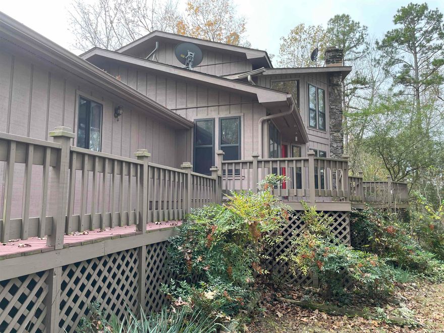 Discover your perfect lake retreat or year-round chalet atop the Lake Forest Estates Subdivision of Tumbling Shoals! This 2,024 SF, 3-bed, 2-bath home features an attached two-car garage and a 720 SF detached shop ideal for lake gear and side-by-sides. Enjoy year-round lake views, a unique lake access point, and serene natural surroundings. Host summer gatherings on 867 SF of expansive wood decking. The kitchen boasts granite countertops, a gas range (LPG), new paint, and flooring, while the cozy living room is warmed by an efficient pellet stove. The upstairs master suite has serene views, and peaceful retreat.  Take a look at Lake Forest Tumbling Shoals!