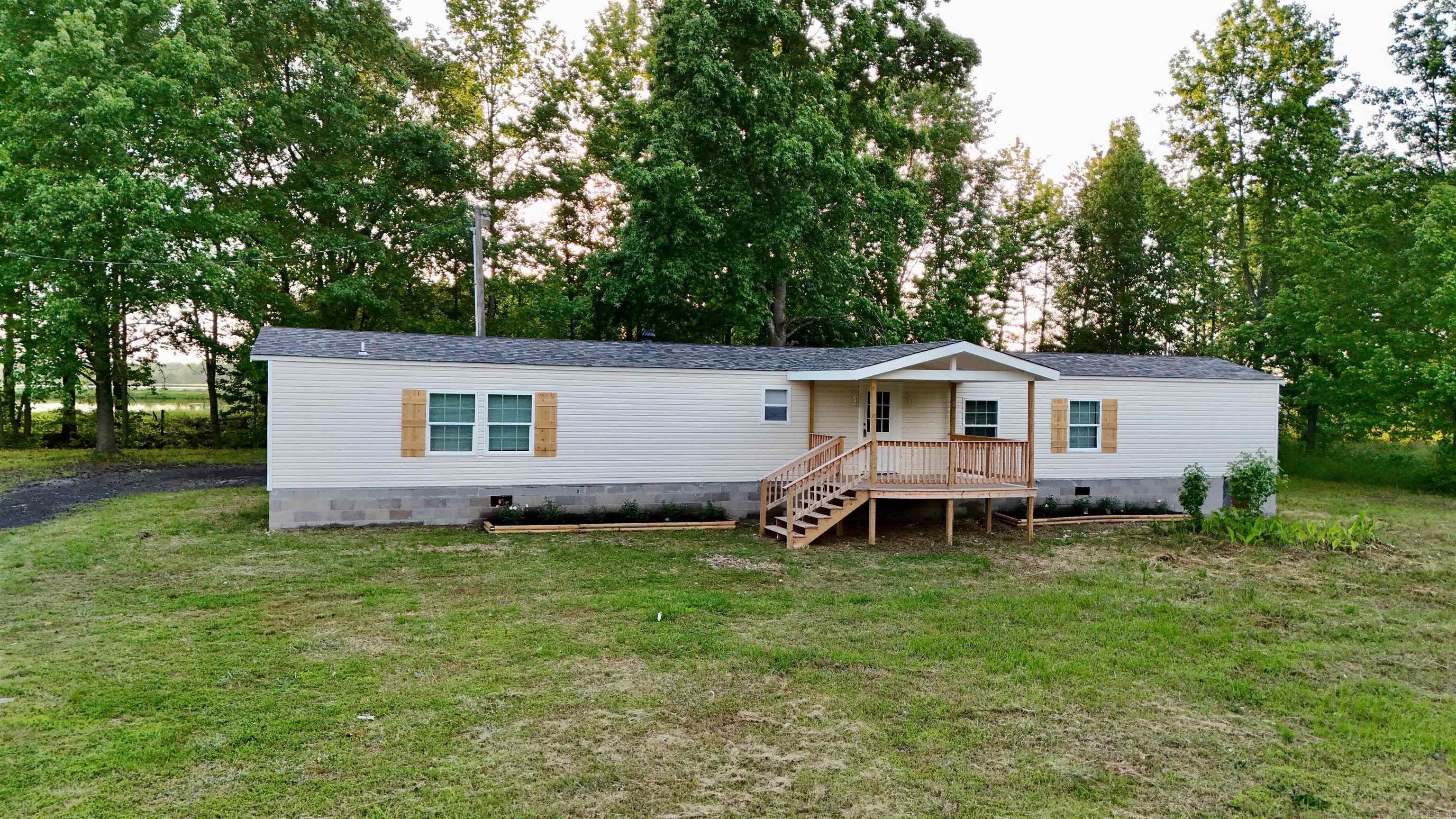 Enjoy living out in the country? Well check out this renovated manufactured home on 3 acres of FLAT LAND! This move-in ready home has 3 bedrooms and 2 baths, an open concept design features a layout where the living, dining, and kitchen areas are interconnected, allowing for greater flexibility and a more spacious feel. Fresh paint and new vinyl flooring throughout the house. Updated bathrooms with beautiful tiles! New deck to relax and enjoy your yard! Please schedule your showing now!