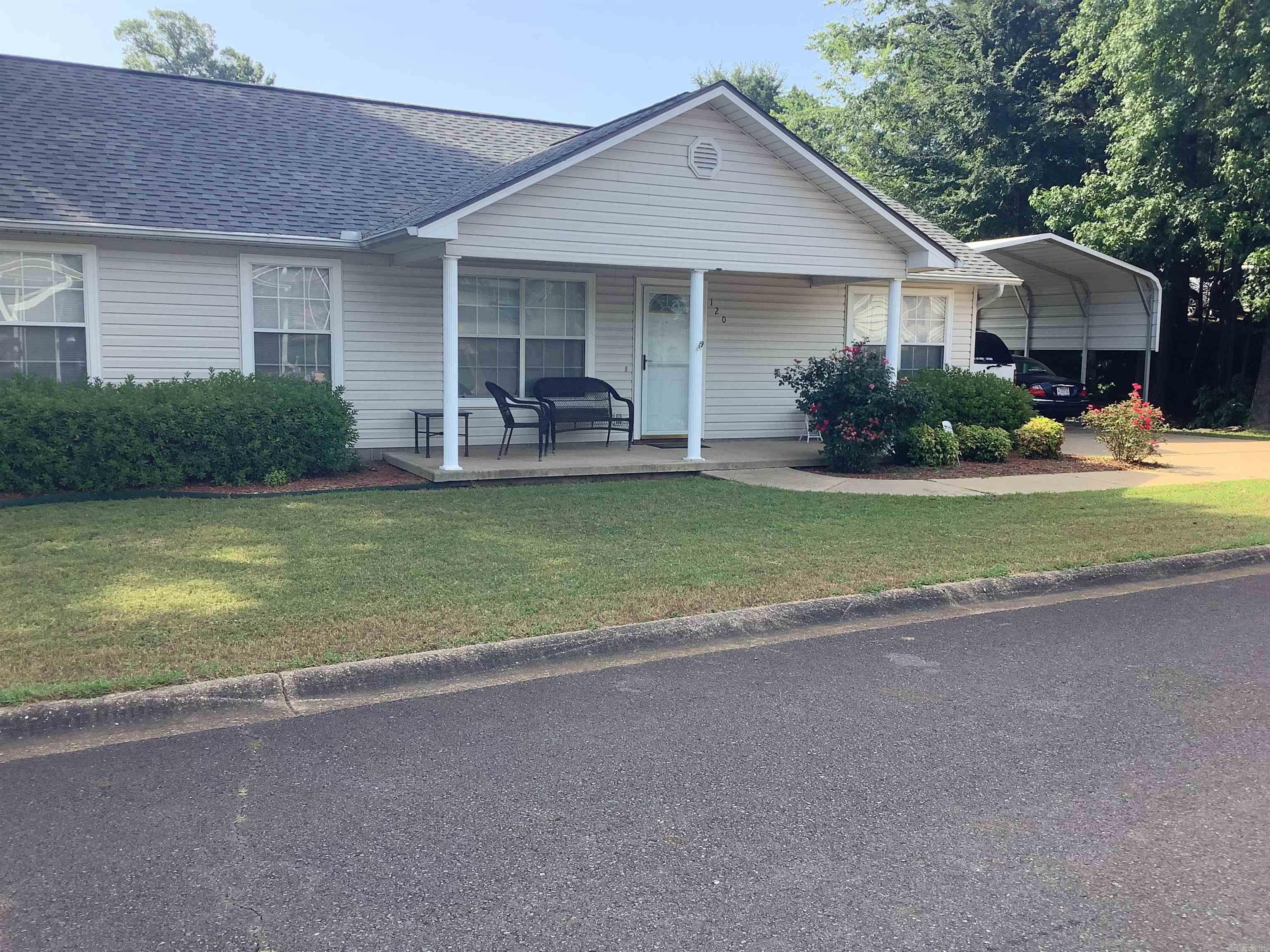 The neatest 2-bedroom, 2-bathroom home in this 55+ community is officially ready for its new owners! With excellent curb appeal, this home features a charming covered front porch and well-maintained landscaping, including shrubs that line the walkway leading from the covered two-car carport. This home on nice corner lot. Inside, you'll find a thoughtfully designed split-bedroom layout. The oversized primary suite includes a private bath and a spacious walk-in closet. The kitchen offers convenient access to the laundry room, complete with a pantry and utility closet. A door leading from the carport into the kitchen ensures you can stay dry on rainy days. The living and dining areas share an open-concept space, with cozy carpet in the living room and durable tile flooring in the dining area. The backyard is small yet inviting, featuring a terraced layout and a raised flower bed that runs along the back wall. This 55 and older neighborhood also offers a welcoming clubhouse with a full kitchen, pool tables, and an exercise roomāperfect for hosting your family gatherings!