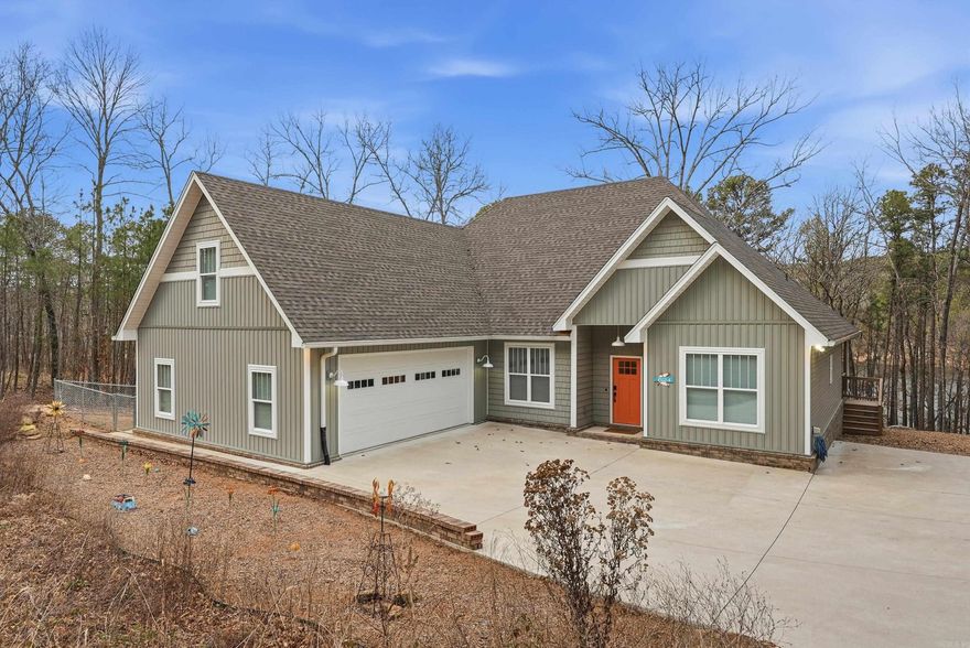 Lakefront living at its finest on Greers Ferry Lake in the beautiful Mystic Isle subdivision. This 4-bedroom, 2.5-bath home offers a perfect blend of modern comfort and retro-inspired style, all set on a cozy, wooded, tree-covered lot just over a half acre with stunning lakefront views and direct access to the water. Inside, you’ll love the inviting living room and bonus room with a modern retro vibe perfect for entertaining or relaxing after a day on the lake. The kitchen is a true standout, featuring a large center island, quartz countertops, custom appliances, abundant cabinetry, a spacious pantry & excellent storage throughout. This home is designed for both function & convenience with a two-car garage plus an additional 16x16 storage area/workshop ideal for lake gear, tools or hobbies. Outside, natural rock landscaping blends beautifully with the wooded surroundings, creating a peaceful & private lakefront setting. Additional highlights include smart-home features: high-speed fiber Wi-Fi, smart thermostat,  garage doors and keypad entry, offering modern efficiency without sacrificing charm. This property delivers the views, access & lifestyle that makes lake living so special.