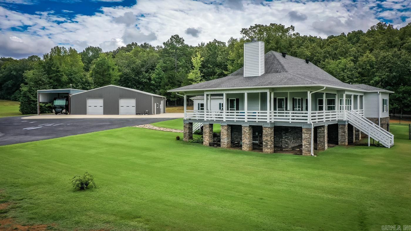 Look no more!! Offering up this one owner pristine property that checks all the boxes! Beautiful Home sitting on 9.5 acres with a park like setting overlooking this beautiful lake that is a dream come true! This property has had no expenses spared when built, including a beautiful wrap around porch to catch that sunset overlooking the water. Beautiful built in cabinetry throughout this home and plank hardwood floors to top it off. Enjoy your wood burning fireplace that centers the living area with an open concept to the kitchen that allows a perfect set up for entertaining guests. This property is in a gated area with only a handful of residents to share with, including entire access to the lake and fishing dock. If that isn't enough, we also have a 2,500 square foot shop that comes heated and cooled with bathroom and laundry hookups to boot. There is also an extra 1,000 sq ft attached Rv storage with 50 amp hookup, water and sewer hookups ready to go! There is an additional 6.6 acres that can be purchased if looking for more land as well. This is truly a one of a kind property that needs NOTHING but a new owner to enjoy!! Come check this beauty out before its too late!