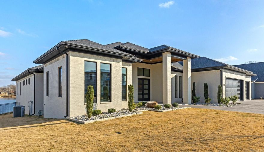 STUNNING CONTEMPORARY ESTATE ON 1/2 ACRE WATERFRONT LOT ON HURRICANE LAKE! All on one level and includes office and private gym/bonus room. Airy and vast living room with gorgeous water views, gas fireplace, and custom built-ins. Kitchen has waterfall island, Fisher and Paykel refrigerator/freezer, 6-burner gas range, double ovens, Butler’s pantry, wet bar with ice maker, and wine fridge. Primary suite has serene vista views, a luxurious bathroom with separate vanities, free standing tub, and jaw dropping custom shower big enough for 2. Gorgeous granite and quartz countertops throughout. Private fitness room complete with bathroom and surround sound, which is also throughout common areas. Inviting veranda with fireplace, outdoor kitchen and bathroom, perfect for entertaining…and the outdoor spa conveys! Seller will consider negotiating many of the furnishings as they are specially tailored for the home. Nestled in quiet gated area of neighborhood.