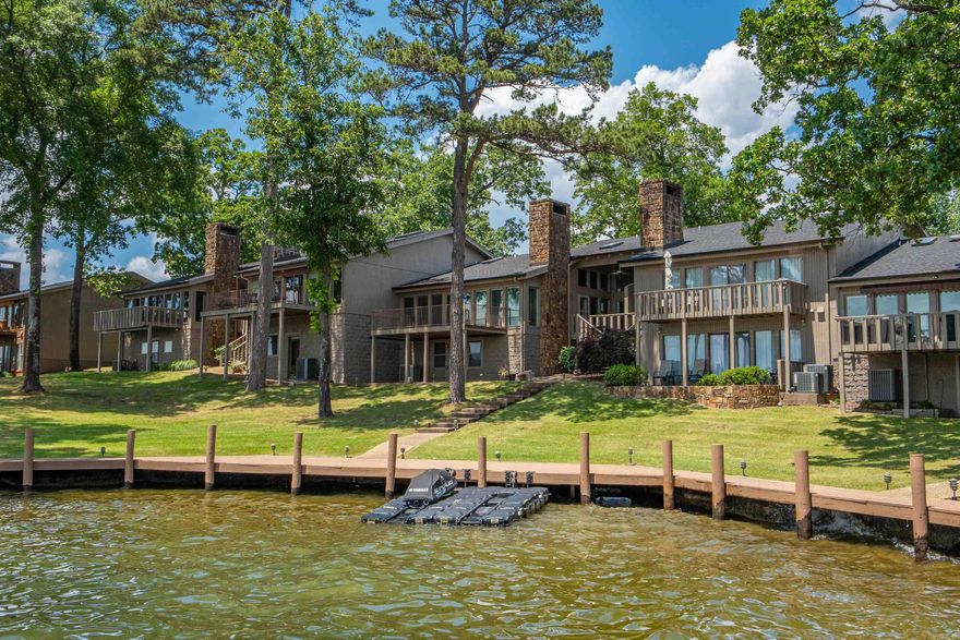 Wonderful location and view !! Step into this 3 bedroom and 3.5 bath with lots of closet space, wet bar with wine fridge and icemaker, stone fireplace, large deck and an open floor plan. Side deck with steps down to lake. Covered boat slip, pool, clubhouseand gated. This complex is very lovely and you will enjoy the grounds, pool and clubhouse. Walk along the boardwalk at the watersedge and enjoy the nice shady lawn areas.
