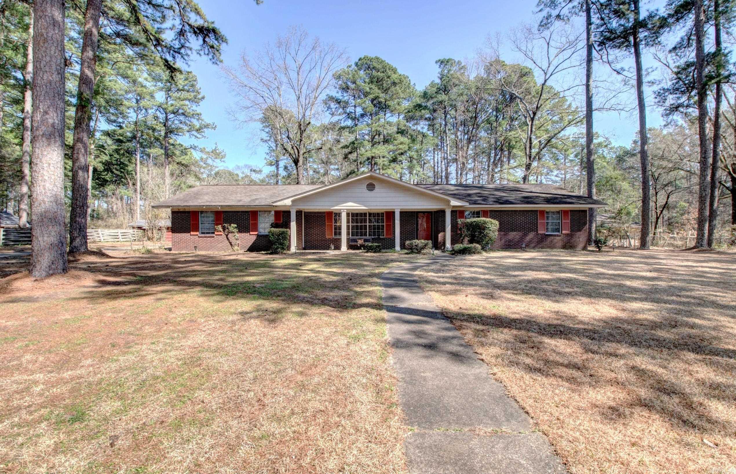 Nestled on a sprawling 1.55-acre lot adorned with mature pine and fruit trees, this charming 2,561 sq. ft. home offers the perfect blend of comfort and functionality. Featuring 3 spacious bedrooms and 2 bathrooms, this home boasts a thoughtfully designed layout with a separate dining room, a formal living room, and a large great room complete with a cozy fireplace. The great room provides seamless access to the expansive backyard, creating an inviting indoor-outdoor living experience. Beyond the main home, a detached, air-conditioned workshop/craft room offers endless possibilities for hobbies, storage, or a private retreat. Whether you're looking to entertain, garden, or simply unwind in a peaceful setting, this property has it all. Enjoy the serenity of country-style living with the convenience of modern amenities. Don't miss the opportunity to make this beautiful home your own!