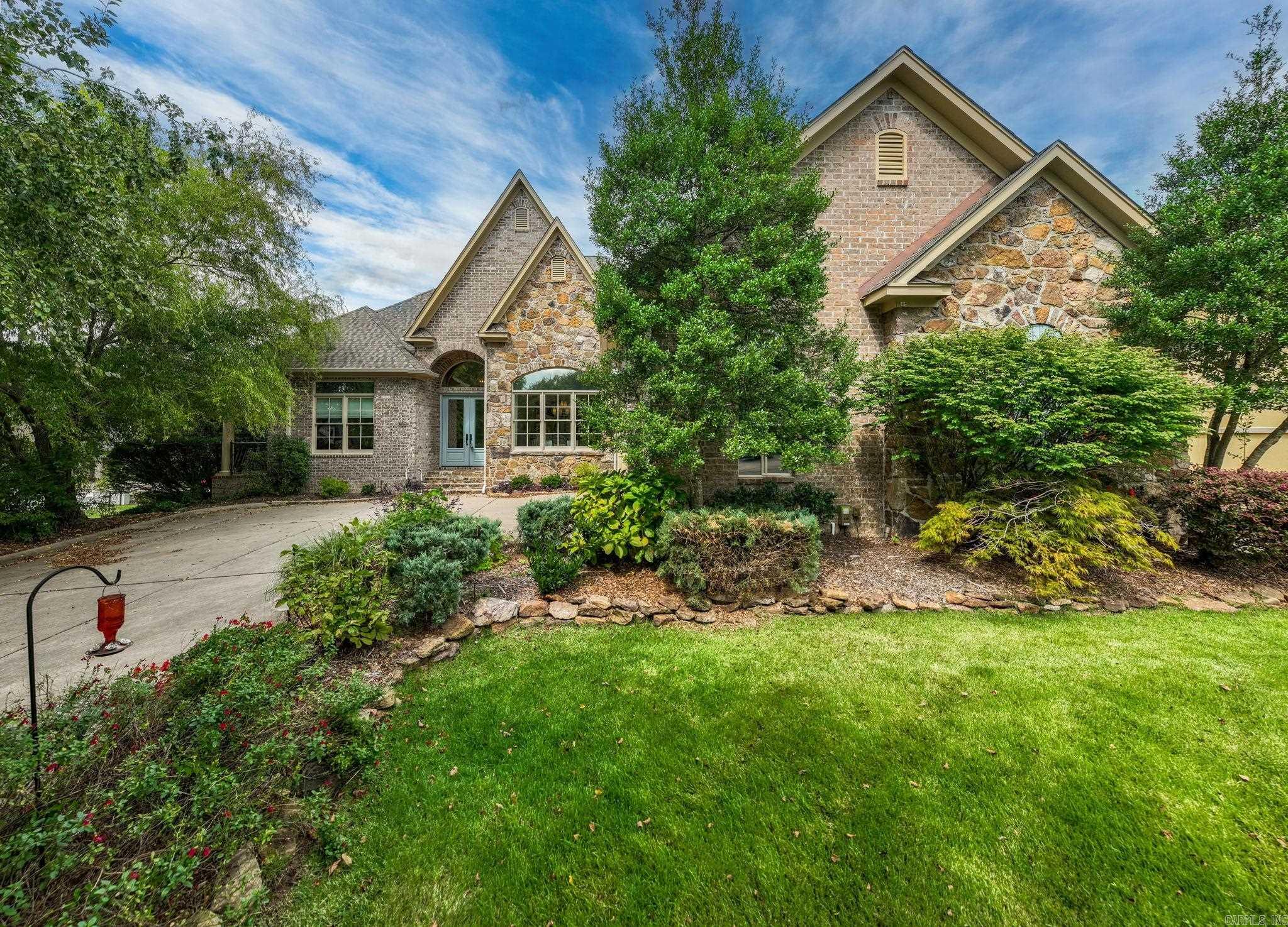 Fabulous home in The ARBORS of Chenal Valley. Gorgeous inside and out. Excellent open floorplan lives like a one level with luxurious primary and two guest bedrooms on the main. Handsome entry flanked by home office with private terrace and banquet formal dining. Spacious family living room that flows into den with fireplace and access to wonderful sun terrace with outdoor fireplace. Gourmet kitchen with top of the line appliances. Upstairs: Large bonus room could be 4th bedroom or media room with wet bar and full bath. Corner Lot with 2 car garage + separate entrance for Golf cart garage! Wonderful location at Chenal's Bear Den golf course and easy ride to beautiful Chenal Valley Country Club. Gated neighborhood. POA provides lawn care.