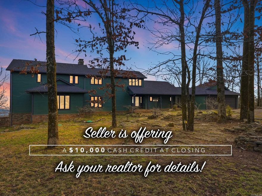 $10,000 CASH ALLOWANCE AT CLOSING! Motivated sellers and no reasonable offer will be refused! Perched high on Petit Jean Mountain with sweeping views of the Arkansas River Valley, this custom-built retreat blends rustic elegance with modern comfort on 2.51 private, wooded acres. Featuring 4 bedrooms, 4 additional bunks, and 3.5 baths, this home is designed for everyday living and unforgettable getaways. Soaring ceilings, hardwood and tile flooring, and a dramatic wall of windows frame the valley views from the gas-log fireplace living room. The kitchen boasts granite tile countertops, stainless steel appliances, and generous cabinetry flowing into a dining area overlooking the landscape. The main-level primary suite offers vaulted ceilings, a private balcony, and a spa-inspired en-suite bath. Upstairs features two bedrooms, a bunk room with 4 built-ins, and a versatile loft. Outside, a massive 2,500 sq ft deck is made for sunsets, entertaining, and mountain serenity. Minutes from Petit Jean State Park, ideal as a primary residence, vacation escape, or short-term rental! Schedule your showing today!