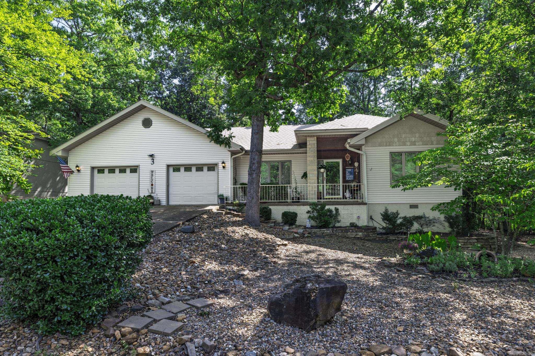 Well-maintained and updated home featuring engineered hardwood flooring and freshly retextured walls with updated paint throughout. The living area offers a gas log fireplace and opens to a light-filled sunroom. A dedicated office is located just off the laundry room. The primary suite includes private deck access and an en-suite bath with its own water heater. Enjoy a spacious wraparound deck with multiple access points from the primary bedroom, office, and sunroom. Additional features include a fenced backyard, whole-house VAC system, and an oversized two-car garage. Conveniently located near the new Dollar General Market for added everyday ease. Modified for VA approval in 2008 allowing you to age in place. Roof 2015. SEE AGENT REMARKS.