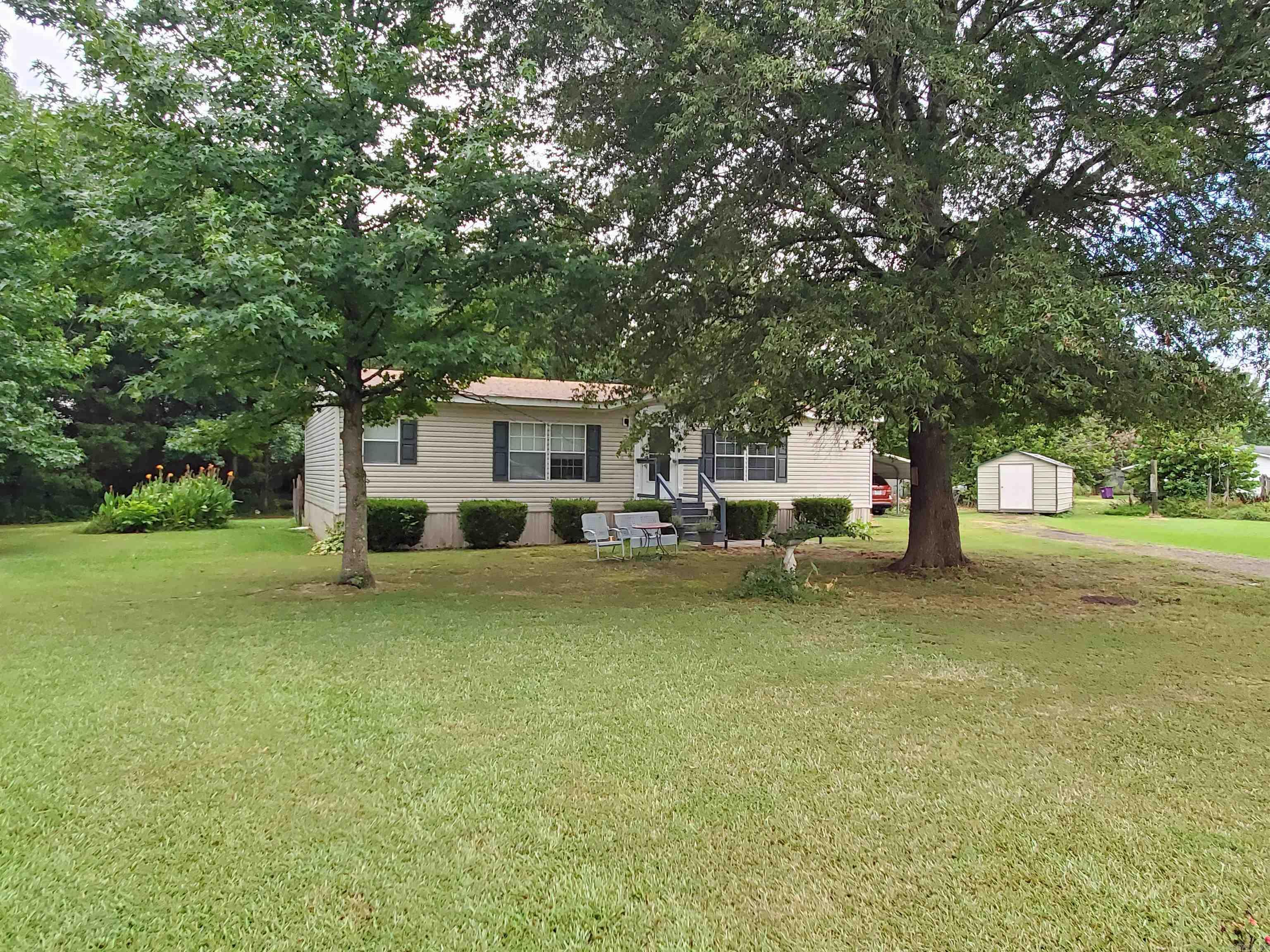 Live the good life on this beautiful 5 acre property teeming with wildlife. Walking trail around entire property. Well kept double wide 3 bedroom 2 full bath Mobile Home. A couple of sheds for storage. Property also has another site with septic and electric for a 2nd MH if needed.
