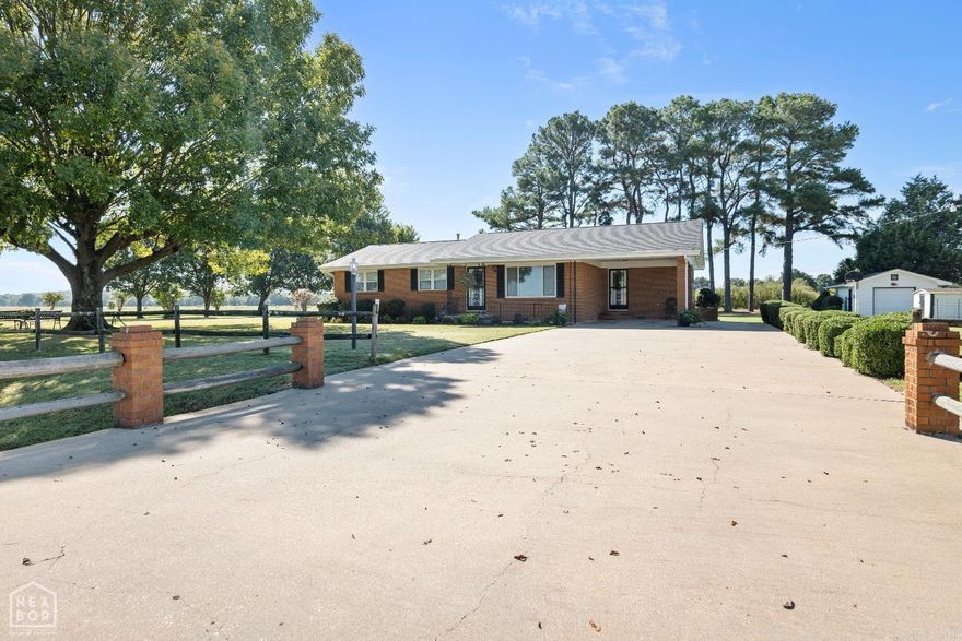 The seller is installing brand NEW heat and air in this house!!!!! Ok... keep reading for the details! Discover your dream home with this beautifully maintained 4-bedroom, 2-bathroom house, perfectly set on a sprawling 1-acre lot. Enter through the inviting open living space, ideal for entertaining family and friends. The spacious kitchen boasts a brand new stove, ample cabinets, and a breakfast bar that flows seamlessly into a large dining area. Enjoy the luxury of updated bathrooms and a separate laundry room, ensuring every corner of this home is both functional and stylish. Step outside to immaculate landscaping, a large driveway, and a serene sitting area under shade trees, perfect for relaxation. The property includes a shop and a small storage shed, providing ample space for hobbies or extra storage. It also has a storm cellar accessible from inside the house to have the comfort of a safe space during weather. With a brand new roof on both the house and the shop, peace of mind is guaranteed. Seize the opportunity to own this charming retreat! Schedule your showing today!