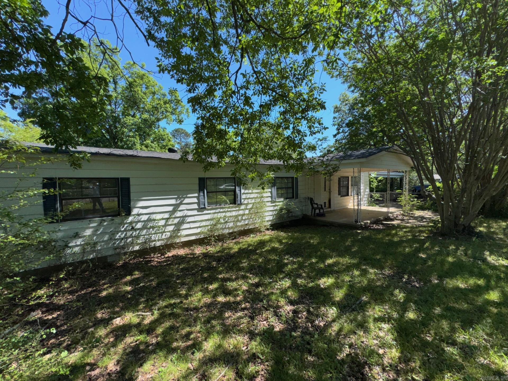 Investors and home buyers take a look at this hidden gem. Mobile home that has had a couple of additions added, 2-3 bedroom 2 bath, bonus room. Tucked away on a completely fenced in yard. nice shade trees, keeps privacy around the home. Has 20x32 shop. Home needs cosmetic work, paint/flooring and just some TLC. Will make a great home at a great price, Hurry before it's gone. Nice size lot, I-30 just a couple minutes away. Priced to sell quickly, contact your agent or the listing agent to assist you with the purchase of this home today. *Make own measurements of home and lot* AGENTS SEE REMARKS