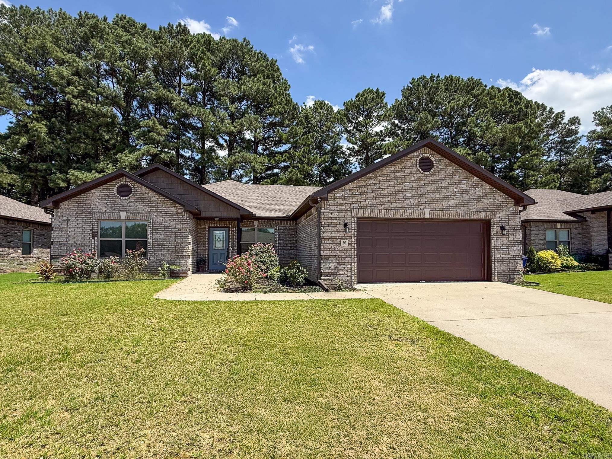 Welcome to this stunning like-new 4 bed, 2 bath home in the highly sought-after Autumn Brooke Estates, located in the Cabot School District! Built in 2022, this 1991 sq ft home offers modern elegance, thoughtful design, and a serene setting. Step inside to find a spacious living room with a cozy fireplace, beautiful coffered ceiling, crown molding, and stylish vinyl plank flooring throughout. The kitchen is a showstopper with sleek granite countertops, a center island, tiled backsplash, stainless steel appliances, and a dining areaāperfect for everyday meals or entertaining guests. Pretty light fixtures throughout add an extra touch of charm! The split floor plan offers privacy with a spacious primary suite featuring a tray ceiling, oversized walk-in closet, and a spa-like bath complete with dual sinks, a soaking tub, and separate stand-up shower. Three additional bedrooms provide space for guests, kids, or a home office. Enjoy the outdoors with a large covered patio and a fully fenced backyard that backs up to the woods. Additional features include a dedicated laundry room, two-car and all the benefits of newer construction with modern finishes. Don't miss this move in ready home!