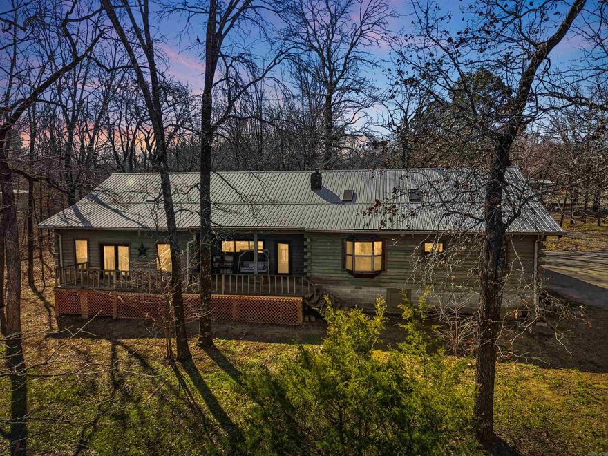 Welcome home to this stunning 3,400 sq ft log cabin nestled on nearly 3 peaceful acres. From the moment you arrive, you’ll love the oversized front porch overlooking the pond — the perfect spot for morning coffee or evening sunsets.  Inside, rustic charm meets cozy cabin with vaulted ceilings, wooden beams, and a breathtaking floor-to-ceiling rock fireplace that anchors the main living space. The layout offers 3 spacious bedrooms, a bonus room, and 1.5 baths with plenty of room to spread out.  Outside, you’ll find an impressive 48’ x 36’ metal shop ideal for hobbies, storage, or workspace needs and a large carport perfect for storing all of your outdoor toys — all while enjoying the privacy of country living just minutes from town and the freeway.   Square footage is approximate. Measuring encouraged. Agents see remarks