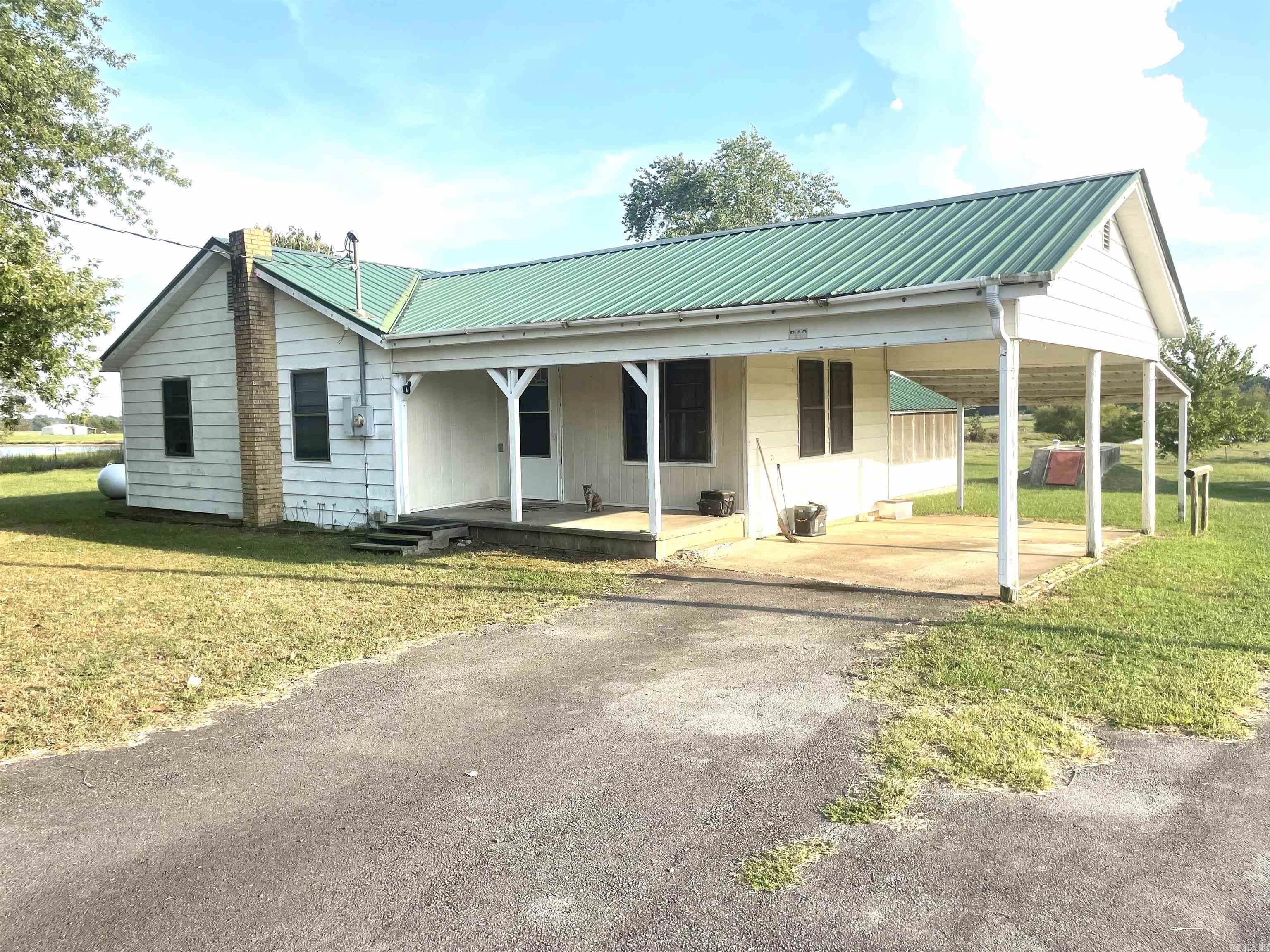 Beautiful tranquil property with several fruit trees including apple, peaches, and pears. This lovely 3 bed home is ready for it's new family to come enjoy. This property offers a 20x30 metal shop with concrete floors and electricity. It also has a storm shelter, lean-to, a screened-in porch, and another smaller storage building. The property has public water but it also has a well that can be used to water plants, wash your vehicle, and much more!! Call today!!!