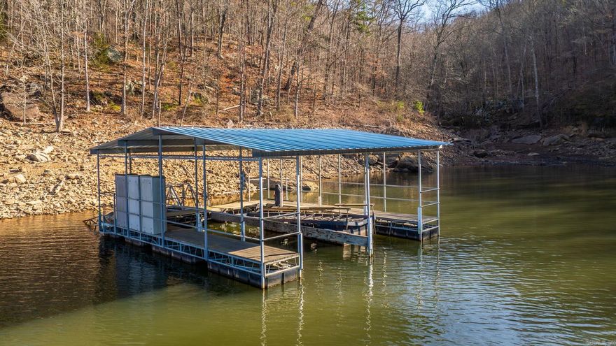 LAKE FRONT with SUNSET LAKEVIEW & 2-SLIP PRIVATE DOCK and it even comes with a 4 bedroom/ 4 bathroom house with all the room for your family or AirBnB guests. This home is move-in ready and recently updated with new paint, Granite Countertops, New backsplash and more all located at the end of the road, making this private retreat the whole package on Greers Ferry Lake.