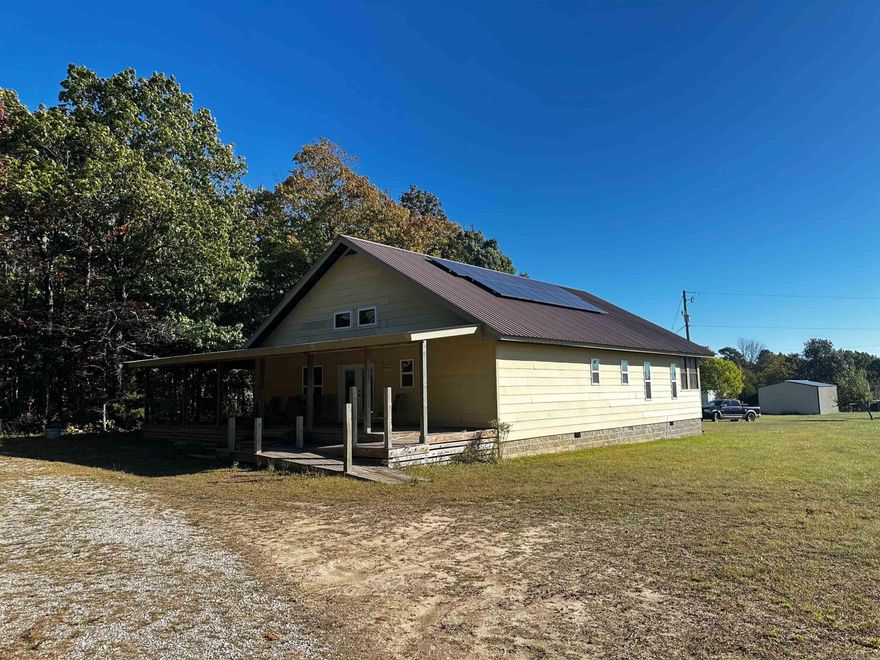 NO 25010: Opportunity awaits with this 1,802 sq ft unfinished home on 11.33 beautiful acres in the heart of the Ozarks. With 9-foot ceilings and Hardie plank siding already installed, this property provides a solid foundation and a blank canvas to complete to your taste. Materials to finish portions of the build are included, giving you a jump start toward your dream retreat. Enjoy 945 sq ft of open porches, a 211 sq ft screened porch, and ample outdoor space for relaxing or entertaining. The property offers city water, solar panels, two septic tanks, and two RV hookups—perfect for hosting guests or tapping into rental potential. One RV will convey with the property. A 22×24 shop and an open storage building supply room for tools, equipment, or projects. With county road frontage and a tranquil, private setting, you get the best of convenience and seclusion. Complete the home to fit your vision—whether as a full-time residence, weekend escape, or investment. Priced to reflect the unfinished status, this is your chance to own a slice of Arkansas.