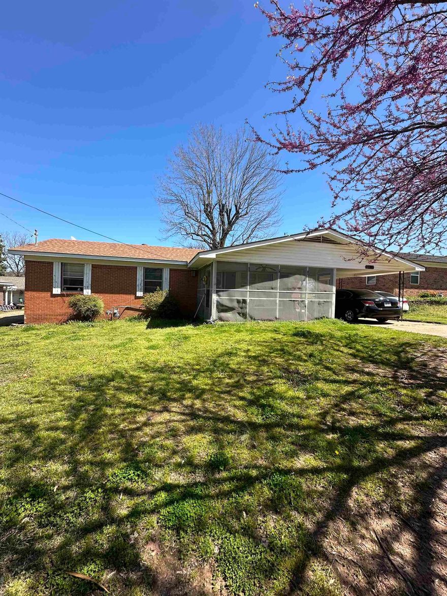 This property, a 3-bedroom, single-bath home with a screened front porch and an additional room in the back, The house is prepared for new ownership or can continue as a rental property. It boasts a landscaped front yard and covered parking, providing a rural lifestyle yet proximity to vital amenities and schools.