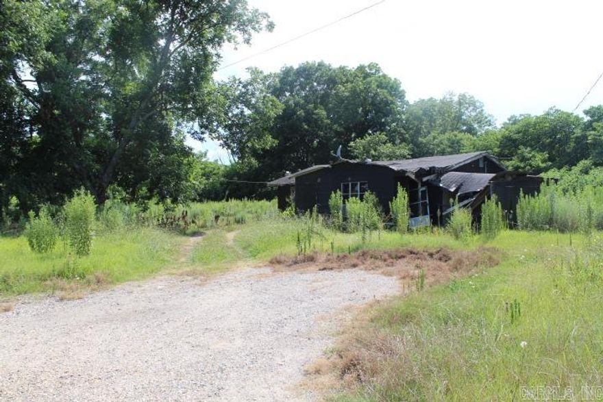 Small acreage parcel on outskirts of Lake Village. Has old falling down house and singlewide mobile home. Neither are in good condition.MH may be occupied.  Property is being sold AS IS.  Land area is estimate.  Copy of fc deed is in docs on line.  This property has been placed in online auction at Servicelinkauction.com.  Auction dates will be updated as they are scheduled. Auction flyer and terms are in docs on line.  Important:  Read the confidential (agent remarks)