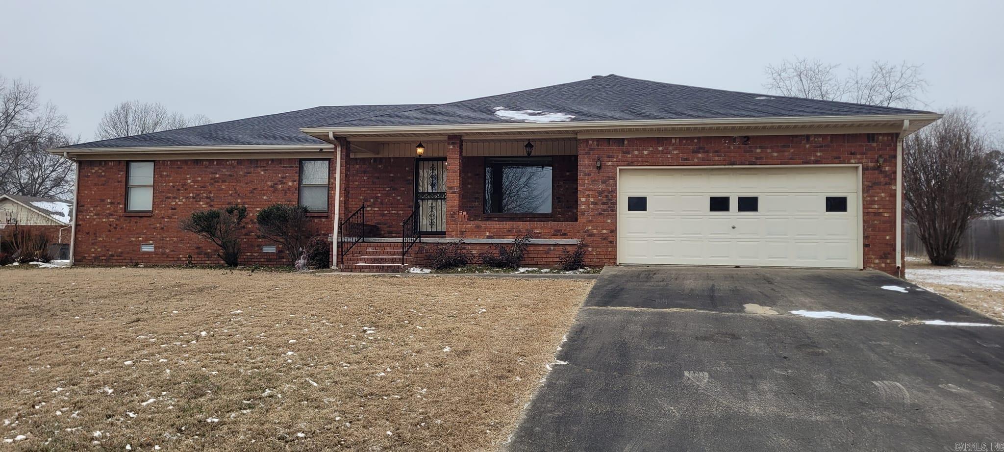 Nestled on a generous .43 corner lot, this 1893 sqft home, built in 1989, is a gem waiting to be discovered. Solidly constructed with a timeless brick exterior, it boasts a spacious 2 car garage and a small shop that's just waiting for your personal touch. New shingles promise durability while the screened-in back porch offers a serene retreat. Inside, you'll find a mix of cozy carpet and sleek tile underfoot. The home's spacious layout, featuring 3 bedrooms and 2 baths, is further enhanced by a warming wood-burning fireplace - perfect for those chilly nights. Priced below comparables, this home presents a unique opportunity for the new owner to update and customize to their taste. Don't miss out on this well-built, spacious home that's just waiting for your personal touch!