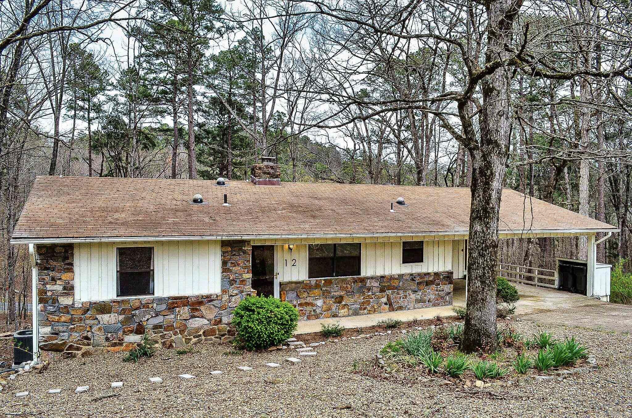 Room for everyone....this 3/4 bedroom 2.5 bath home has oodles of room. Entry level hosts 3 bedroom and 2 full baths. Lower level offers another possible bedroom and half bath. Depending how you arrange the floor plan, you could have an entry level formal dining room or office/hobby area or downstairs a roomy workshop plus game room. Wonderful deck overlooks nature's beauty. Split bedroom floor plan with native stone fireplace. Hot Springs Village Property Owner Association has a new member buy-in fee of $2,000.00 due and collected at closing.