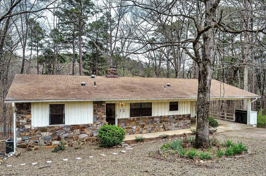 Room for everyone....this 3/4 bedroom 2.5 bath home has oodles of room. Entry level hosts 3 bedroom and 2 full baths. Lower level offers another possible bedroom and half bath. Depending how you arrange the floor plan, you could have an entry level formal dining room or office/hobby area or downstairs a roomy workshop plus game room. Wonderful deck overlooks nature's beauty. Split bedroom floor plan with native stone fireplace. Hot Springs Village Property Owner Association has a new member buy-in fee of $2,000.00 due and collected at closing.