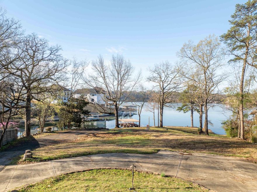 Introducing an unparalleled opportunity to own a slice of paradise on Lake Hamilton! Nestled on one of the last remaining point lots, this premium lakefront property boasts over 225 feet of pristine shoreline, offering unrivaled panoramic views of the glistening waters. Strategically positioned in the heart of Lake Hamilton, this gem is not only a waterfront haven but also centrally located by both land and lake, ensuring convenient access to the area's finest amenities and attractions. Imagine waking up to the tranquil sounds of nature and the breathtaking sight of the sunrise dancing across the water from your custom-built dream home. With ample space and a blank canvas, this lot invites you to bring your vision to life and create the ultimate lakeside retreat. For developers with a keen eye, the potential of this property is limitless. With its prime location, expansive views, and two-stall boat dock already in place, seize the opportunity to capitalize on the booming demand for luxury lakefront living. Don't miss your chance to own a piece of paradise on Lake Hamilton.
