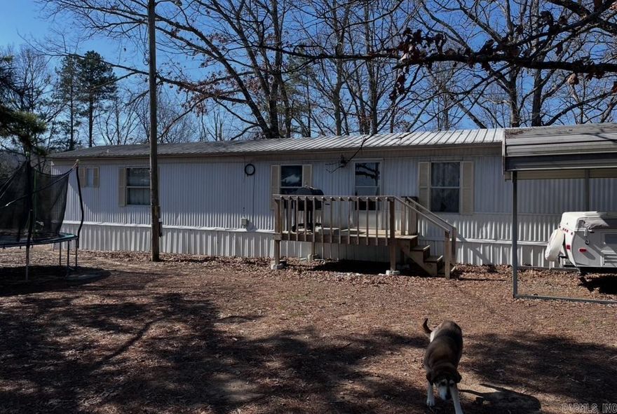 Beautiful mobile home on 4 acres in Bee Branch Arkansas with storage building and storm cellar and ever famous chicken coop w/ pen .
