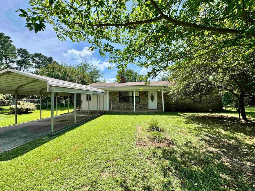 Well maintained home sitting on a half acre lot filled with fruit trees.  Completed fenced level yard.  Bright and clean interior with a double sided wood burning fireplace.  Large living and dining areas. Covered parking with pole barn in back yard and additional storage building. Enclosed carport could easily be a third bedroom. This home is move in ready.