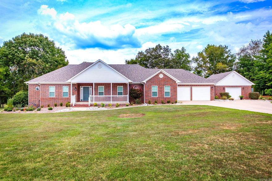 This well-built home features a new roof, new heating/air system, & new gutters, ensuring long-term durability & comfort. Inside, you'll find 10' ceilings in the main living areas and 9' ceilings throughout the rest of the home, and a large primary bedroom & bathroom, creating a spacious & airy atmosphere. The property includes a paved driveway, 2-car garage, plus a 21x23 attached garage/shop for your hobbies or storage.  A 6-person storm shelter & whole home generator provides added safety & peace of mind  The 919 sq ft covered porch, manicured lawn & fire pit are perfect for entertaining your friends and family. Additional amenities include a 30x30 shop with electric, a 22x24 storage building, and three 225-gallon rain barrels connected to the gutters for efficient water collection. Conveniently located just 15 miles from Lacey's Narrows Marina & state campground on Greers Ferry Lake and less than 18 miles from Greenbrier, this home offers both tranquility and accessibility. Seller is offering a one year home warranty with accepted offer.