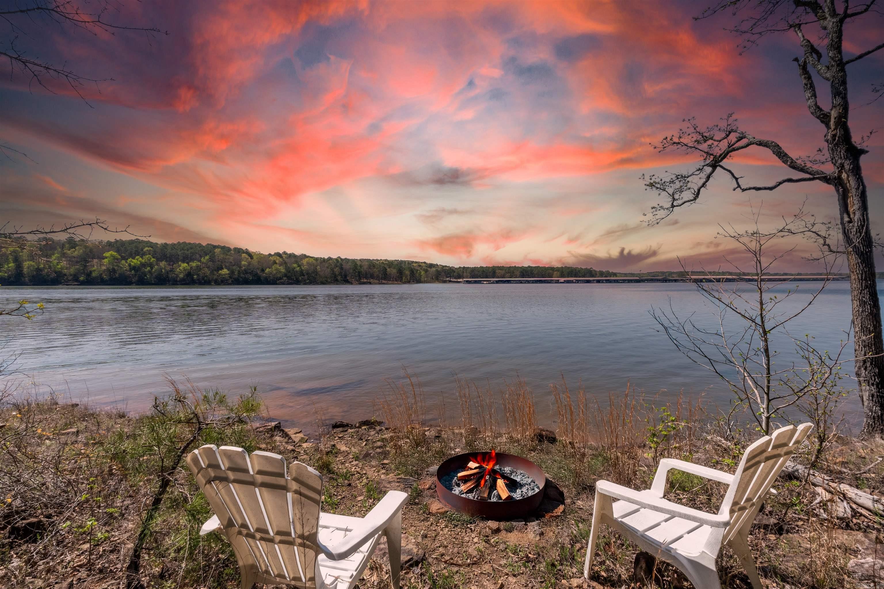 Lakefront Retreat in Tumbling Shoals – Private Paradise with Guest House Welcome to your dream lakefront home! Nestled at the end of a peaceful cul-de-sac, this unique property offers a rare blend of privacy, comfort,& access to Greers Ferry Lake. The main home features 2 spacious bedrooms & 2.5 baths, a stunning open-concept design including a large great room & a gourmet kitchen perfect for entertaining. Natural light fills the living area, a covered deck provides the perfect place to unwind while enjoying the best sunsets on the lake & the soothing sound of a seasonal stream beside the home. Just steps away, a charming 2-bedroom guest house offers extra space for visitors. There's even a dedicated office in the garage, great for working from home or creative pursuits. With 120 feet of shoreline, you can swim, board your boat, or simply relax by the water. The property features both dramatic cliffs & accessible shoreline, blending beauty & convenience. Just across the lake from Dam Site Marina, you're never far from lake life. Whether you're seeking a full-time home or weekend escape, this lakeside haven offers unforgettable views, flexible living space, & the amazing sunsets