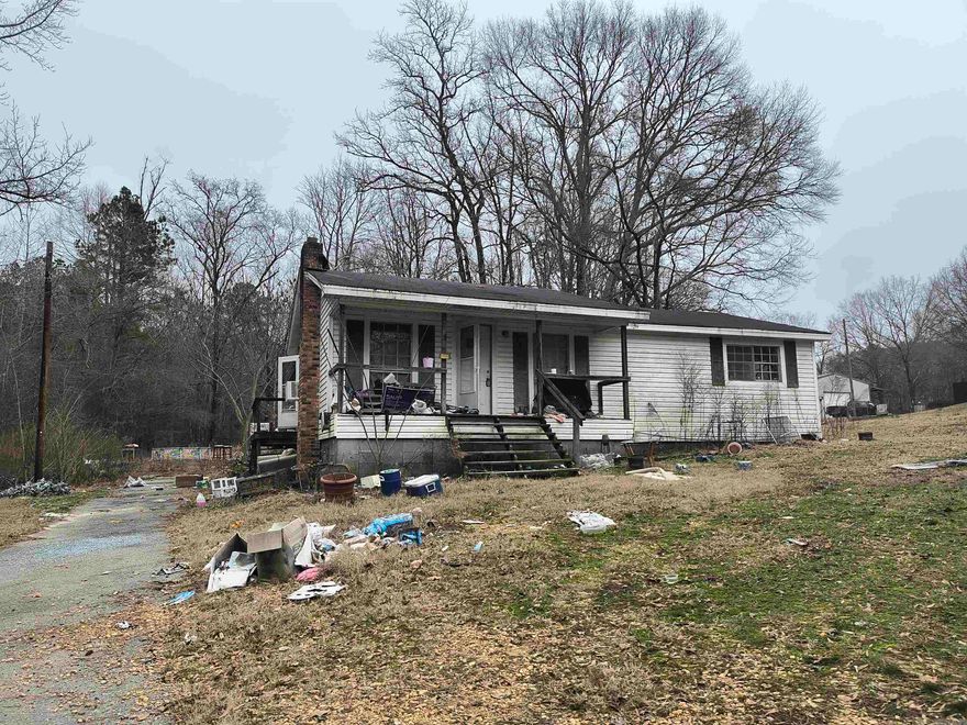 Fixer Upper! Please be aware the back bedroom subfloor has fallen in and all caution should be taken when viewing. Seller recommends having a foundation inspection done on the property.