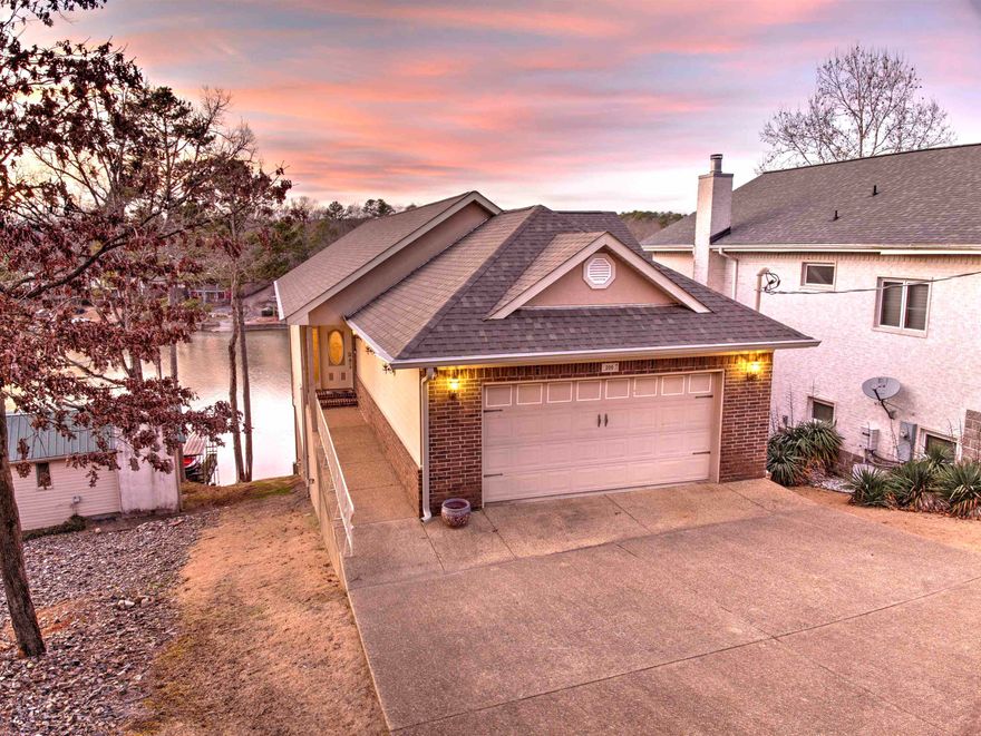Must see this beautiful and well-maintained 4 Bedroom 4.5 Bath home on Lake Hamilton! The interior includes an open floor plan w/ vaulted ceilings, a chef's kitchen, and large primary bedroom/bathroom on the main level. The second level includes three bedrooms, two bathrooms, a living room, and a laundry room.  The third level contains yet another living area perfect for a pool table, a bathroom, and a small kitchen that is handy when taking food or drinks to the dock. The exterior has multiple covered porches and a deck to enjoy the beautiful lake views, an outdoor cooking area with a built-in gas grill, a two car garage, and additional parking. The covered boat dock is equipped with a lift that will convey.  The house is already set up for short term rentals with exterior RING cameras and Schlage electronic locks. Both sets of washer/dryers, the upstairs refrigerator, and all the mounted TV’s are being left for the new owners.  The house is close to a POA park with a boat ramp.  All of this with easy access to the historic Hot Springs. Call for your private showing today!