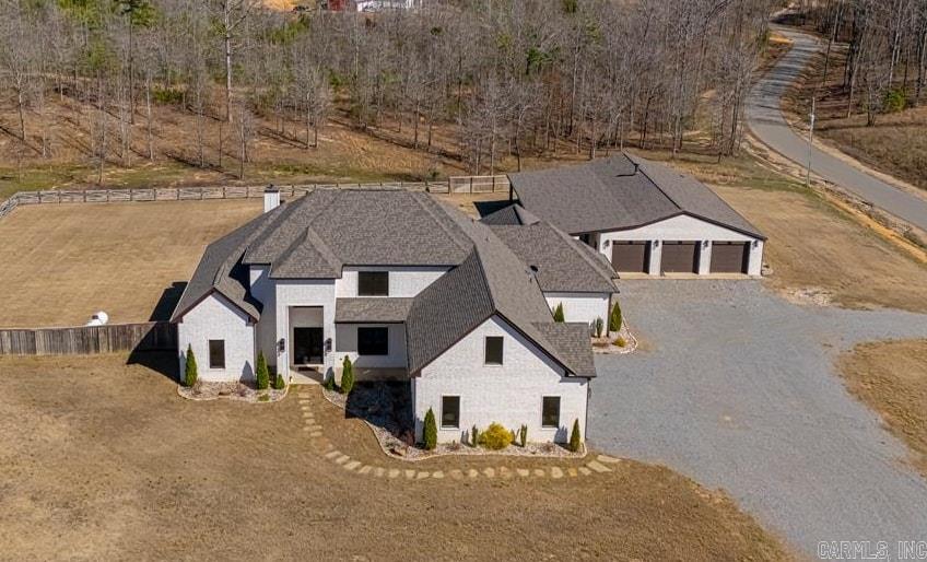 $25K IN SELLER CONSESSIONS AVAILABLE! Get ready for all your boxes to be checked! Land, pool, shop with living quarters & a stunning custom-built home! Home spans 4,531 SF, plus a 2,400 square foot shop (approx. 1,200 SF of living space), ALL of which is heated and cooled! The moment you walk through the door, you're greeted by an open, luxurious floor plan filled with natural light overlooking the saltwater pool. Beside the two-story entryway is a built-in bar area with seating and beautiful ceiling detail throughout the kitchen and living areas. The primary suite will make you never want to leave. The closet is a dream for any clothing enthusiast, featuring multiple levels of hanging racks and shelving, along with a custom area for dressing or applying makeup. The spa-like bathroom includes a relaxing walk-through shower and safe room! All bedrooms are located on the main level, including a versatile office that can serve as a 4th bedroom. Upstairs, you will find two spacious bonus rooms, media closet & full bath. Shop living space has 1 BD, 1.5 BA, walk in shower, dbl vanity, Full kitchen, living room with fireplace and laundry! Please see attached custom upgrade list!!