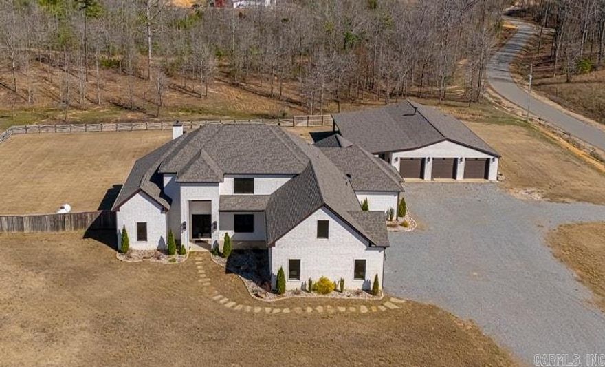 $25K IN SELLER CONSESSIONS AVAILABLE! Get ready for all your boxes to be checked! Land, pool, shop with living quarters & a stunning custom-built home! Home spans 4,531 SF, plus a 2,400 square foot shop (approx. 1,200 SF of living space), ALL of which is heated and cooled! The moment you walk through the door, you're greeted by an open, luxurious floor plan filled with natural light overlooking the saltwater pool. Beside the two-story entryway is a built-in bar area with seating and beautiful ceiling detail throughout the kitchen and living areas. The primary suite will make you never want to leave. The closet is a dream for any clothing enthusiast, featuring multiple levels of hanging racks and shelving, along with a custom area for dressing or applying makeup. The spa-like bathroom includes a relaxing walk-through shower and safe room! All bedrooms are located on the main level, including a versatile office that can serve as a 4th bedroom. Upstairs, you will find two spacious bonus rooms, media closet & full bath. Shop living space has 1 BD, 1.5 BA, walk in shower, dbl vanity, Full kitchen, living room with fireplace and laundry!  Please see attached custom upgrade list!!