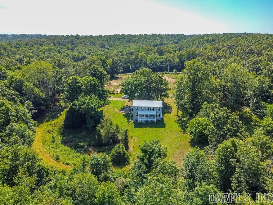 Welcome to Market 8437 Oak Ridge Rd. of Ravenden Springs, AR in Randolph County. With caves, creek, and cross fencing on site for horses, you'll be sure to love this Colonial Revival nestled on 18.35 +/- wooded acres.  The exterior is wrapped in vinyl, topped w/ a metal roof, and accented by a cozy front porch. The 2 story farmhouse style interior offers 2,000 sf of well laid out living space over 2 floors containing a Master bedroom w/ en-suite on the main level, 2 spare bedrooms and full bath upstairs, open concept living/kitchen/dining that includes a grand living room w/ wood beams & wood burning stove, kitchen that any pampered chef would be proud of that boasts a gorgeous island, stainless steel appliances, subway tile backsplash, and large pantry, a private office, half bath, and laundry room. The surveyed grounds hold a 24 x 20 detached garage w/ 220v, 20 x 20 barn, and small orchard of pears, apples, and plums.  Per Seller recent improvements include: laminate floors, septic system (2019), and well (2022). Paved road frontage, located near Eleven Point River and AR-90. Call today to schedule your tour and make this rare offering your home, home away from home, or Airbnb.